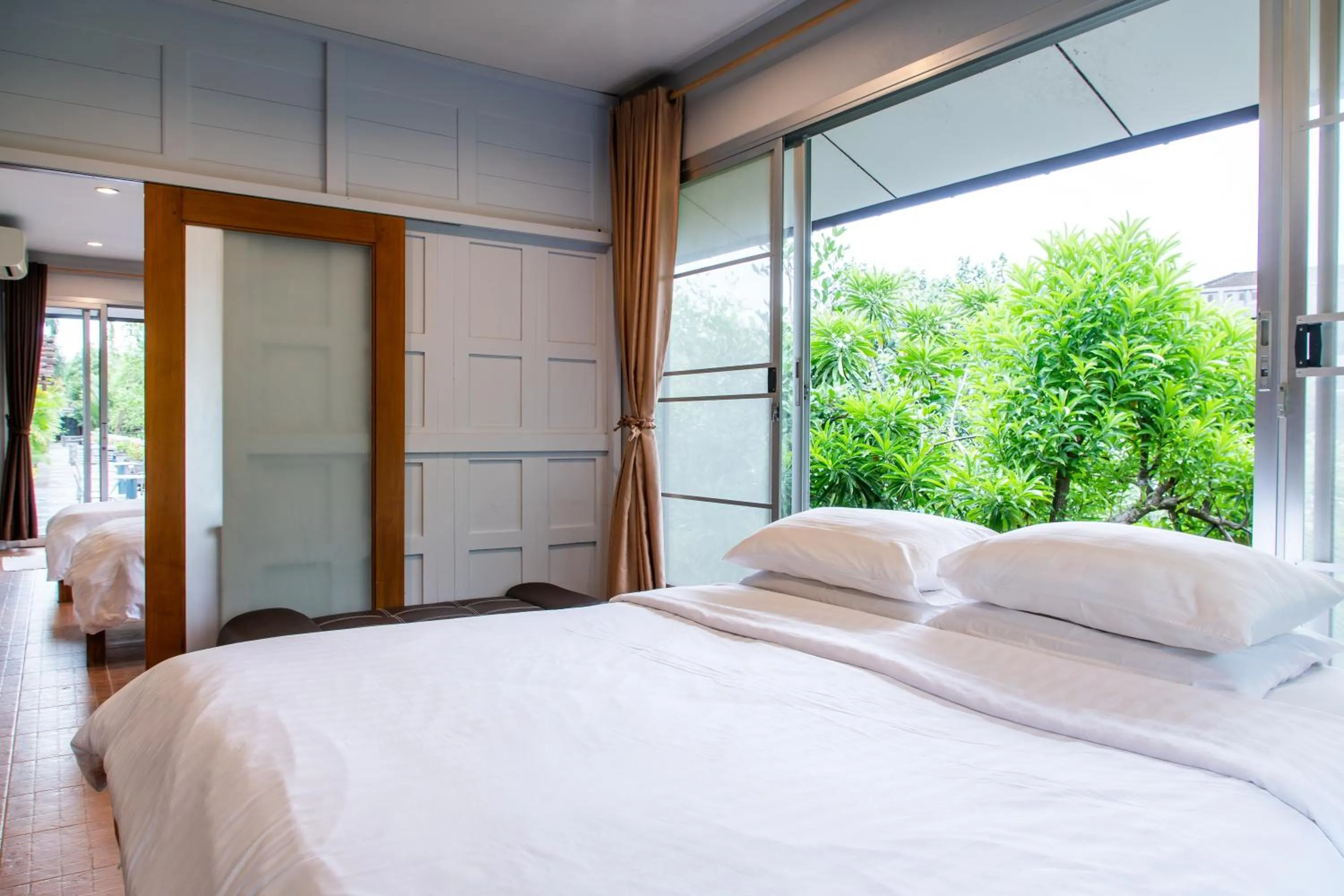 Bed in BaanRimNam Resort Trat