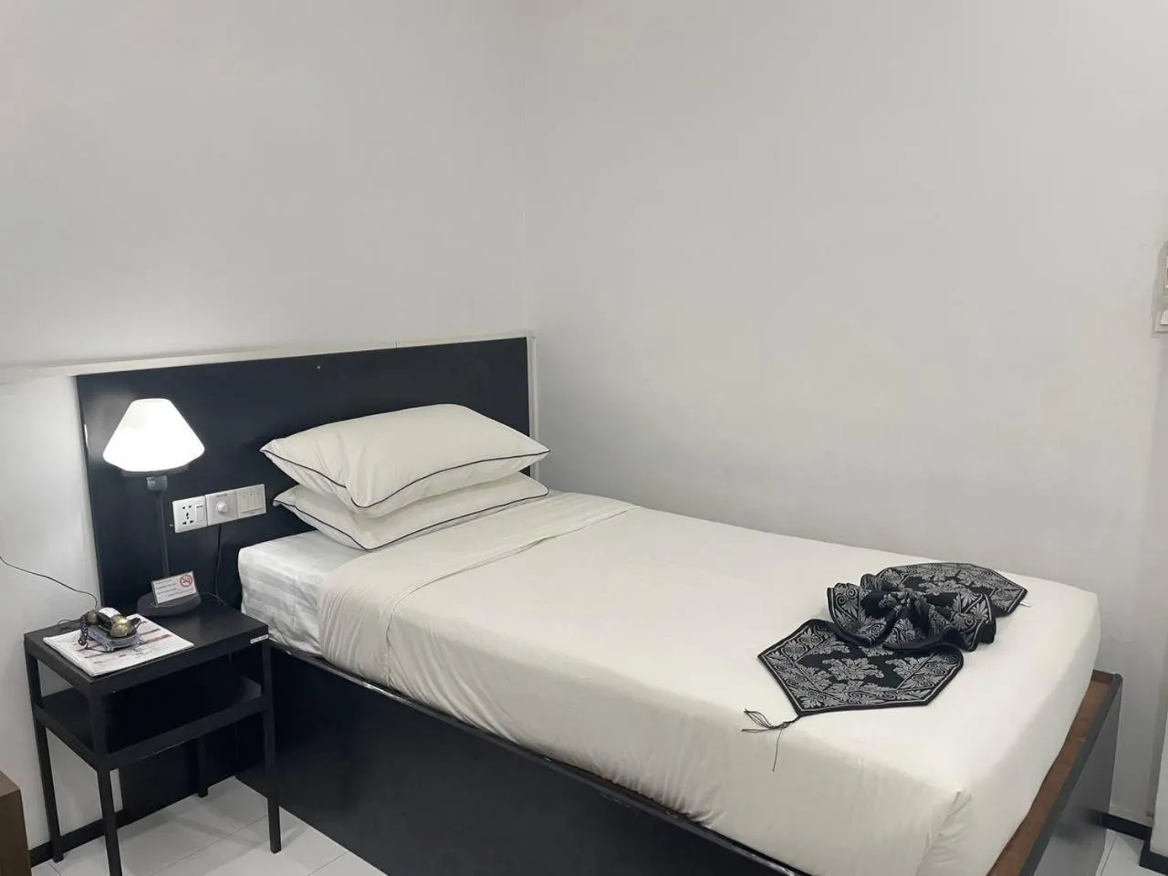 Bed in YAMA HOTEL & ROOFTOP BAR