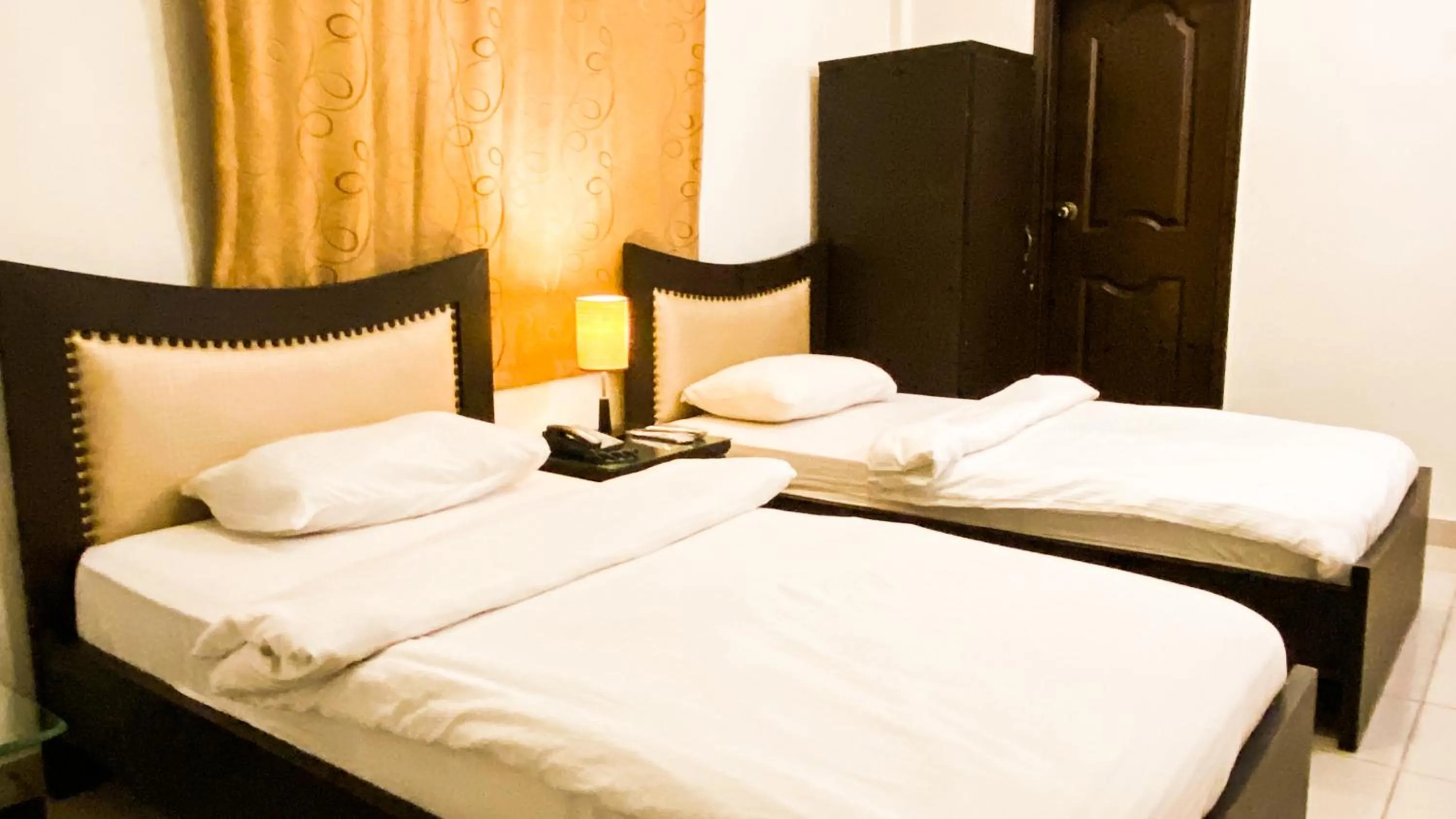 Bed in Royal Inn Hotel