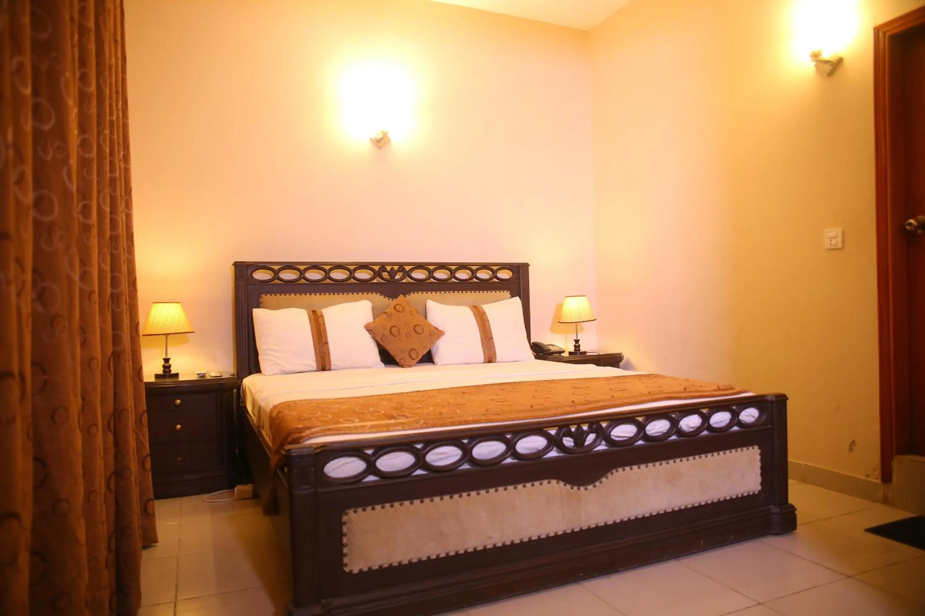 Bed in Royal Inn Hotel