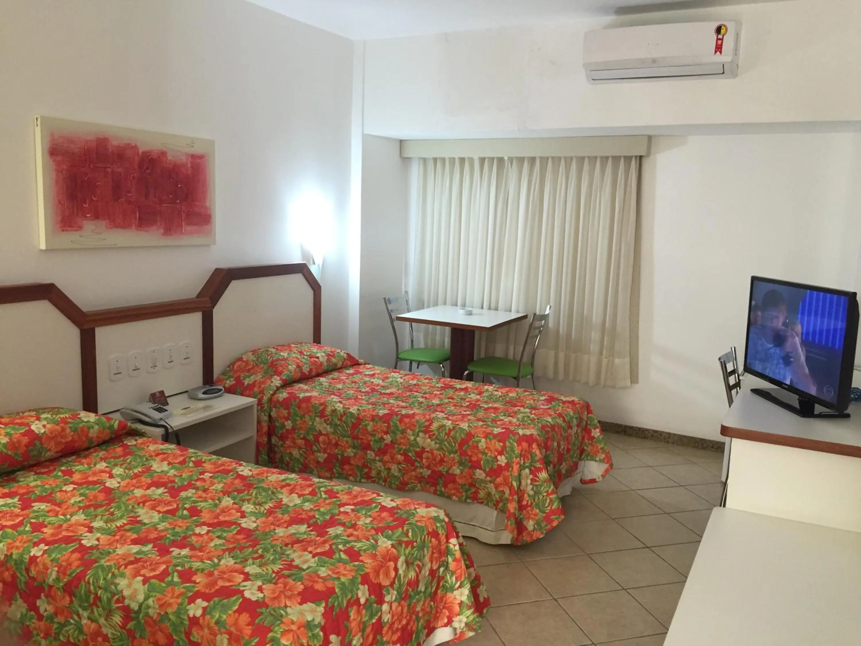 Communal lounge/ TV room, Bed in Lord Plaza Hotel