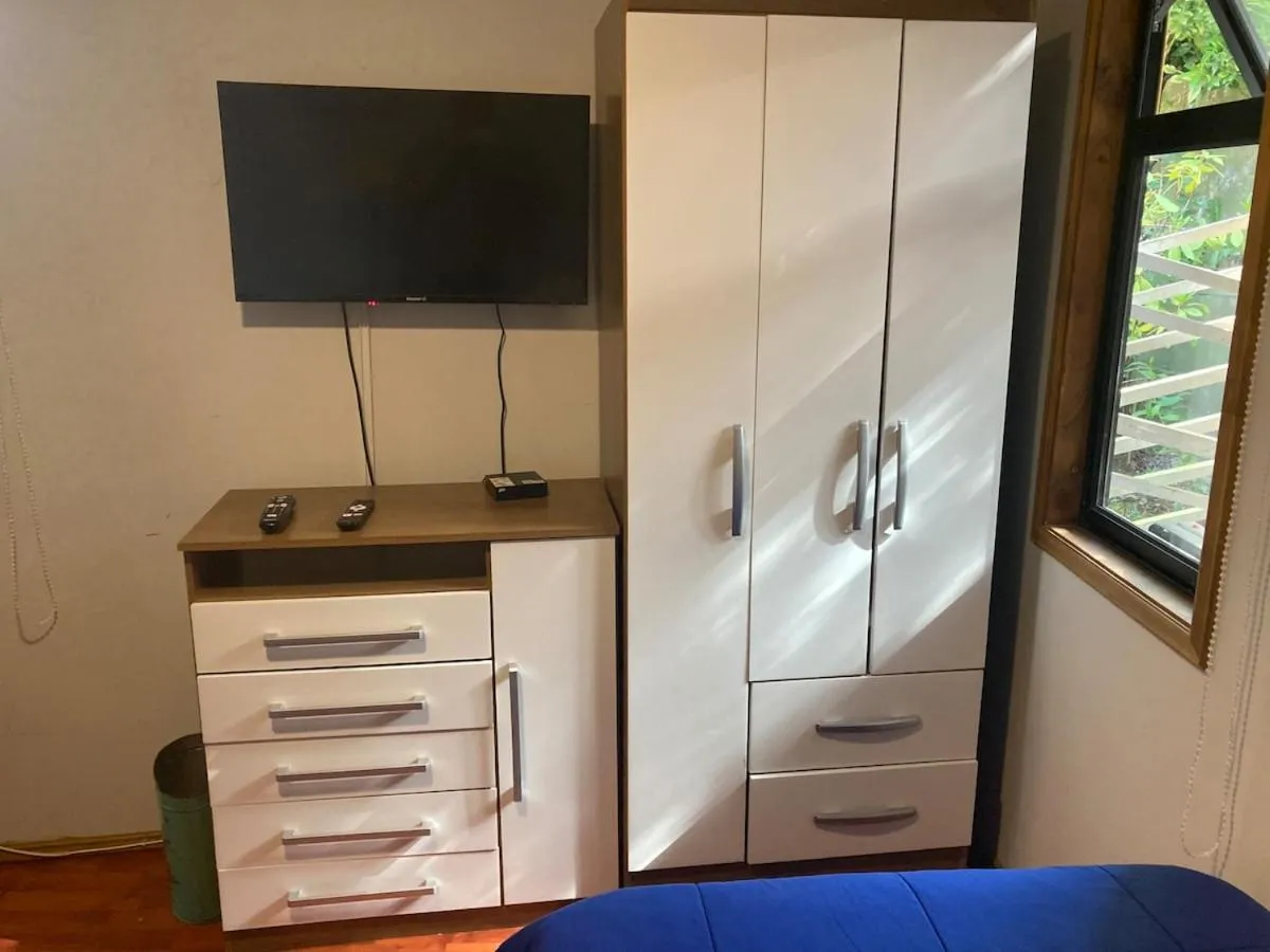 wardrobe, Bed in Hospedaje El Roble, Puerto Varas
