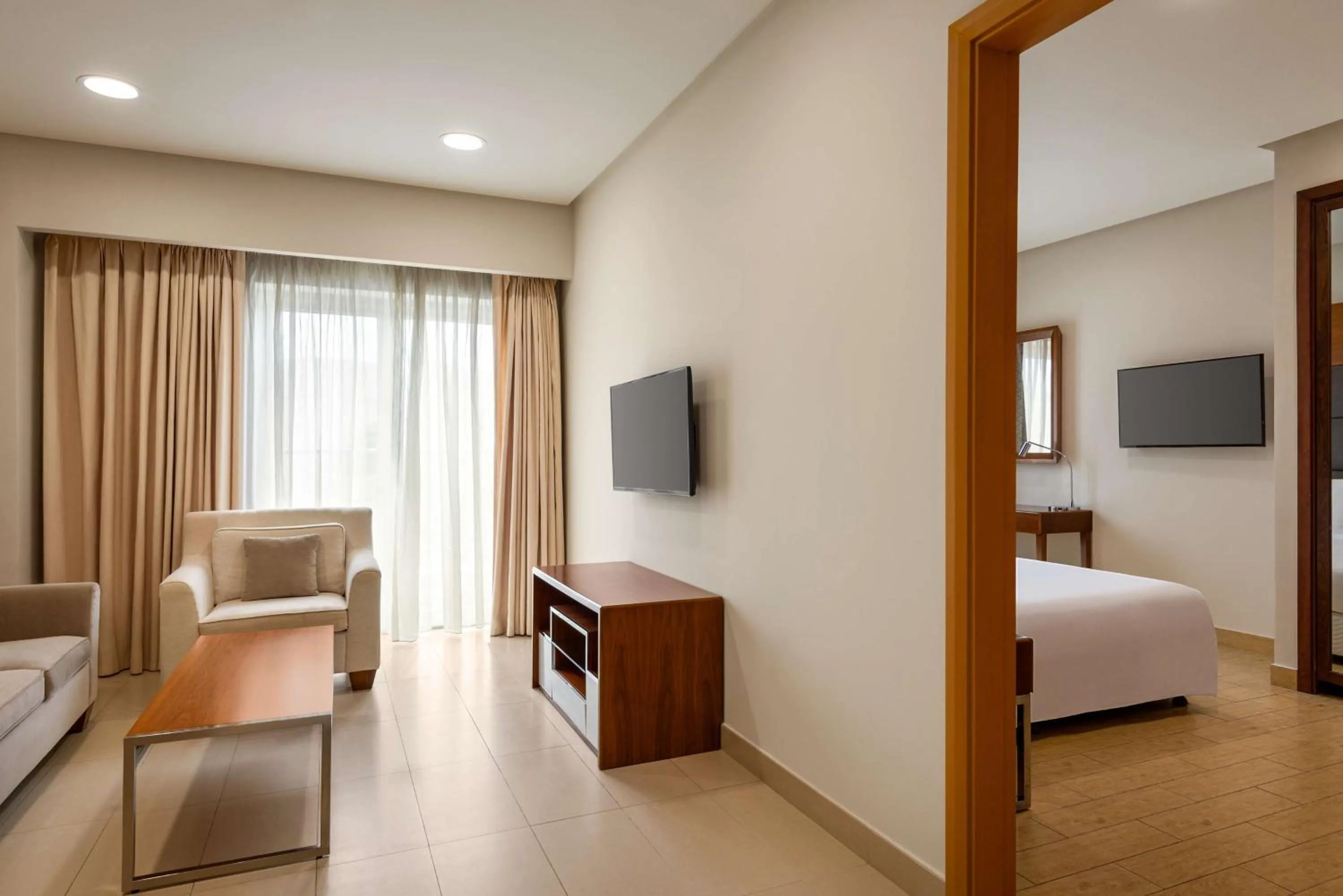 Communal lounge/ TV room, Bed in Levatio Suites Muscat, a member of Radisson Individuals