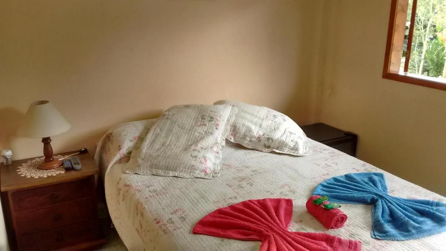 Bed in Sítio e Pousada Recanto Dos Ipês