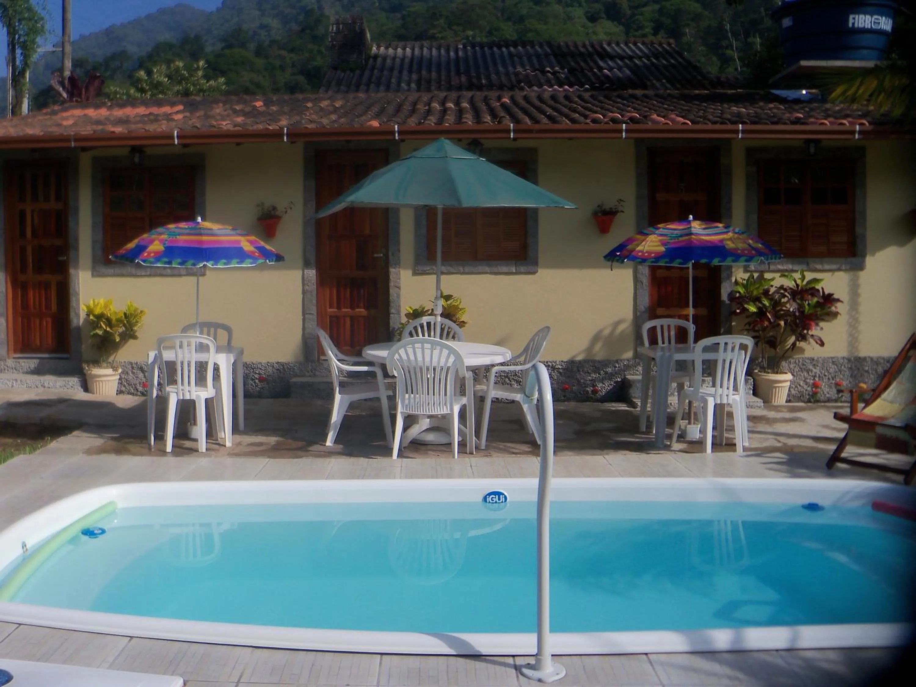 Swimming pool in Sítio e Pousada Recanto Dos Ipês