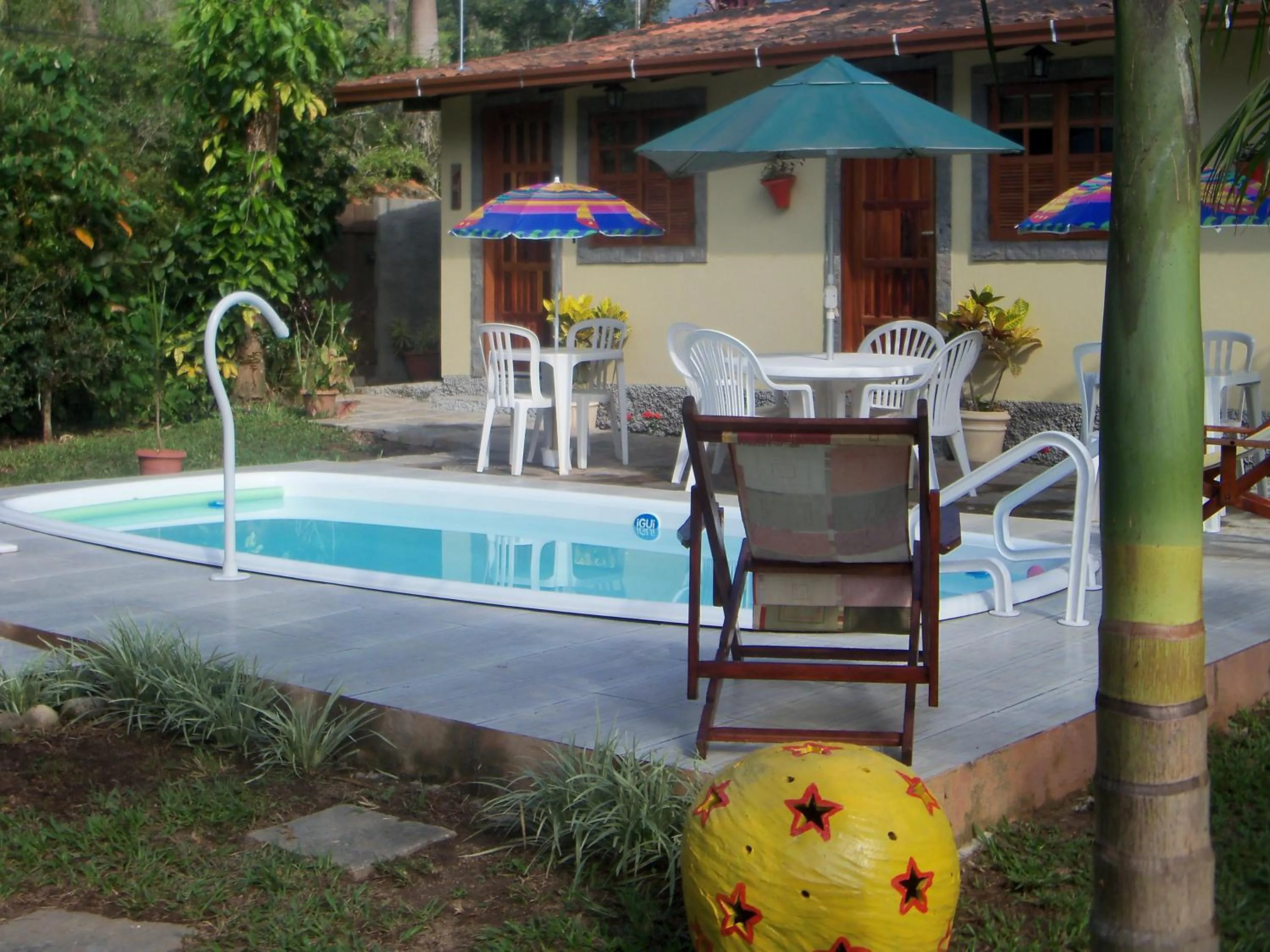 Swimming pool in Sítio e Pousada Recanto Dos Ipês