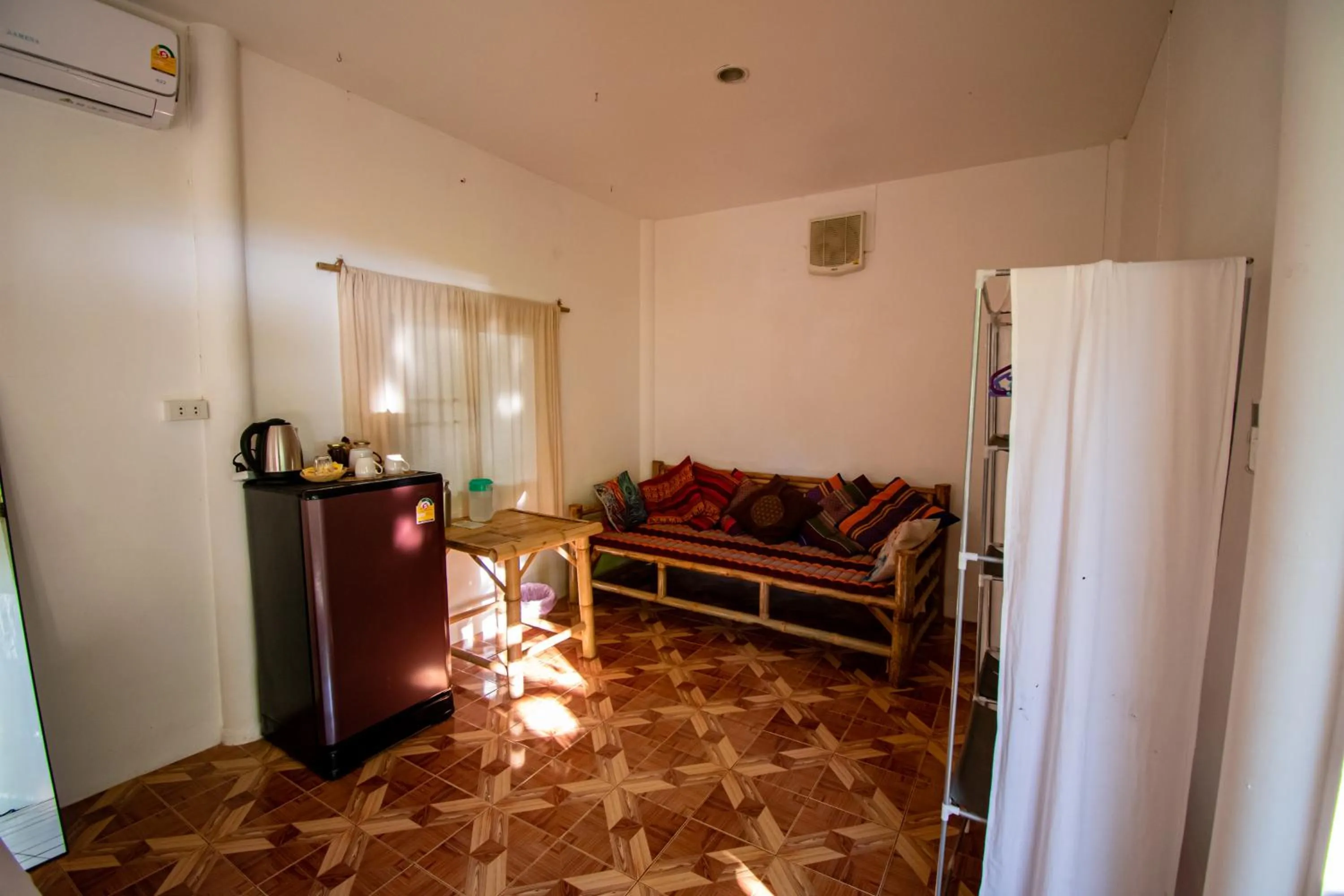 Seating area, Bed in Colorful Hut