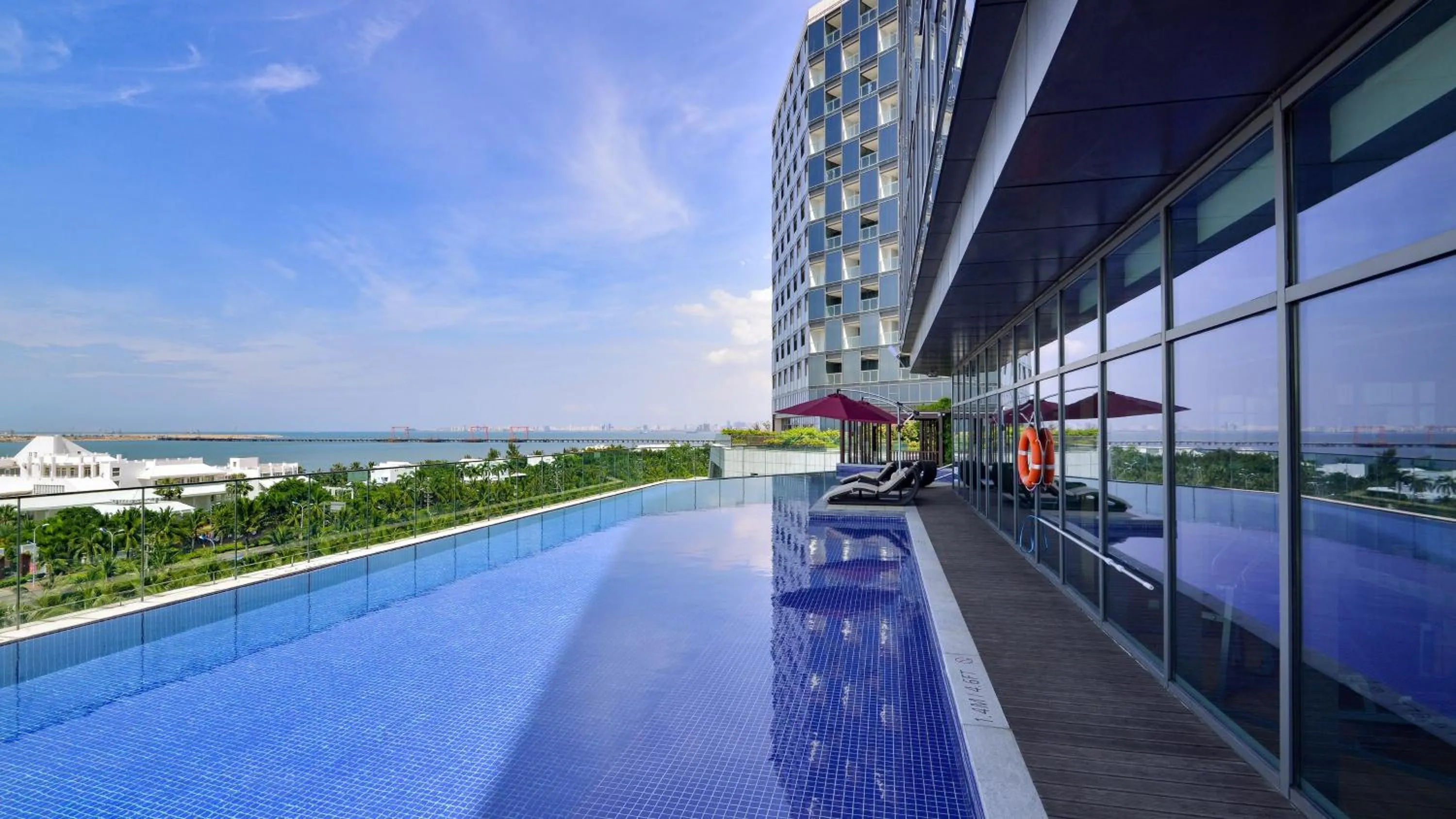 Swimming pool in Holiday Inn Haikou West Coast by IHG