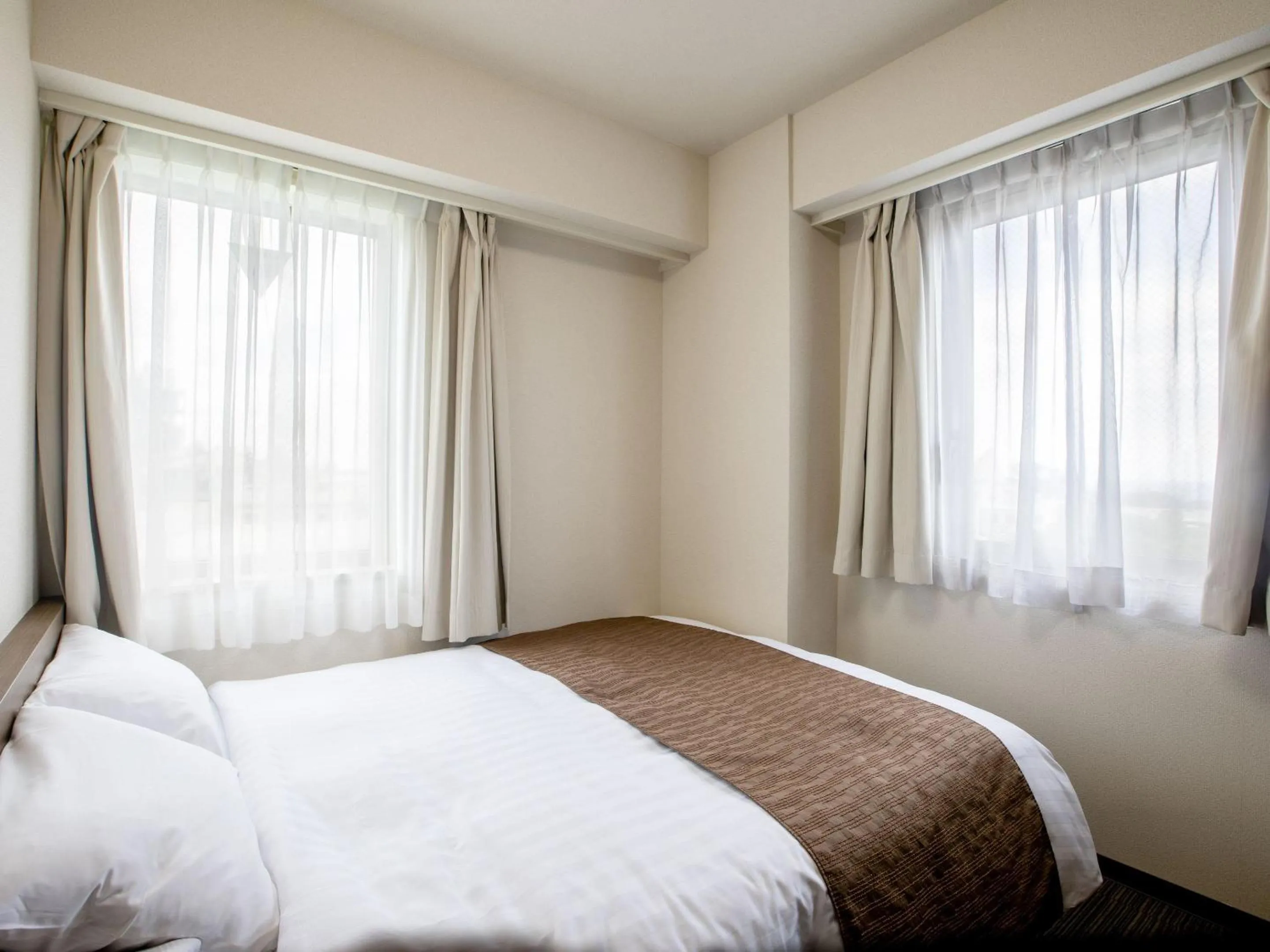 Bed in KOKO STAY Hitachi- formerly Hotel Wing International Hitachi