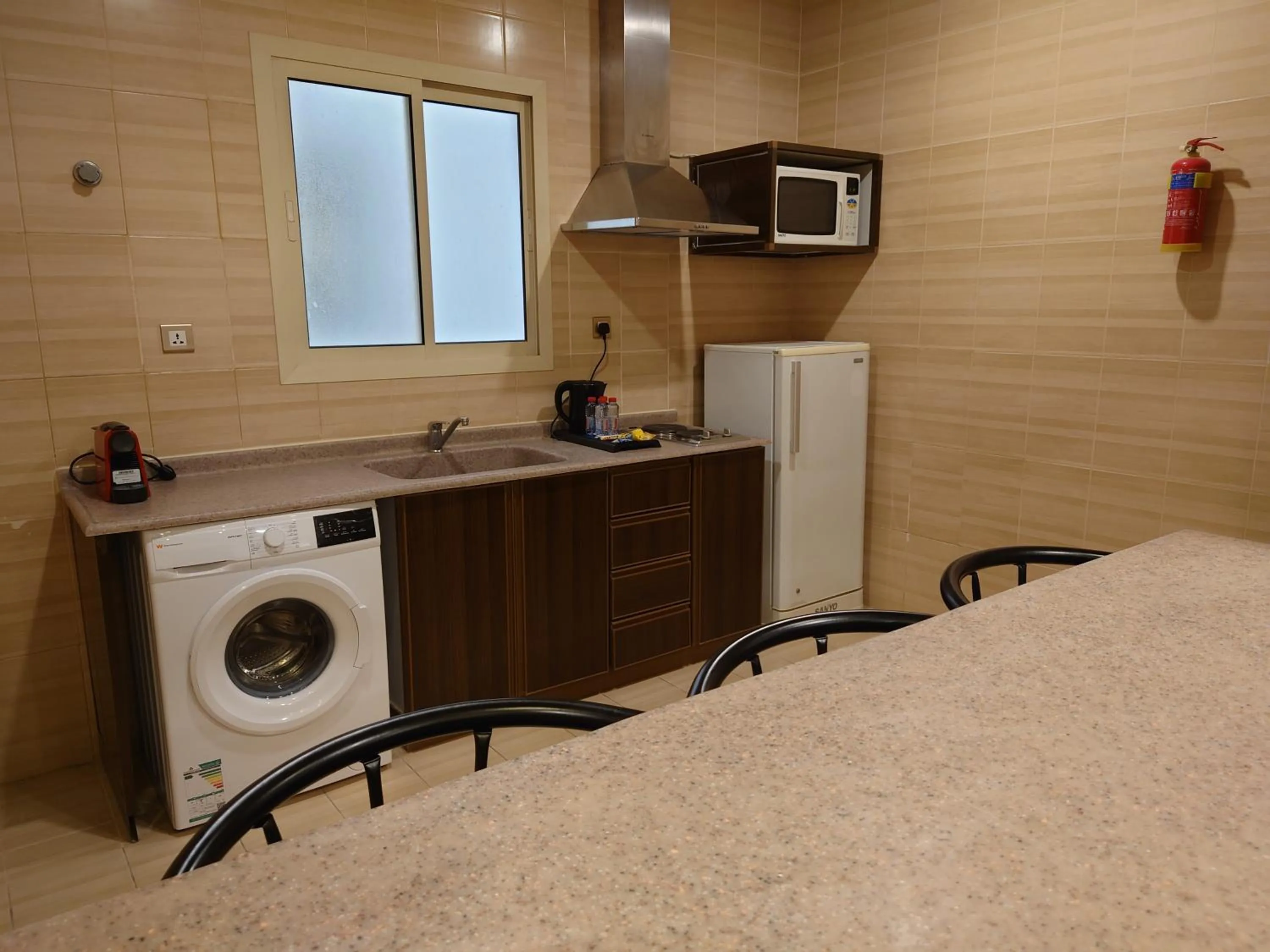 Kitchen or kitchenette in Travellerinn Serviced Apartment