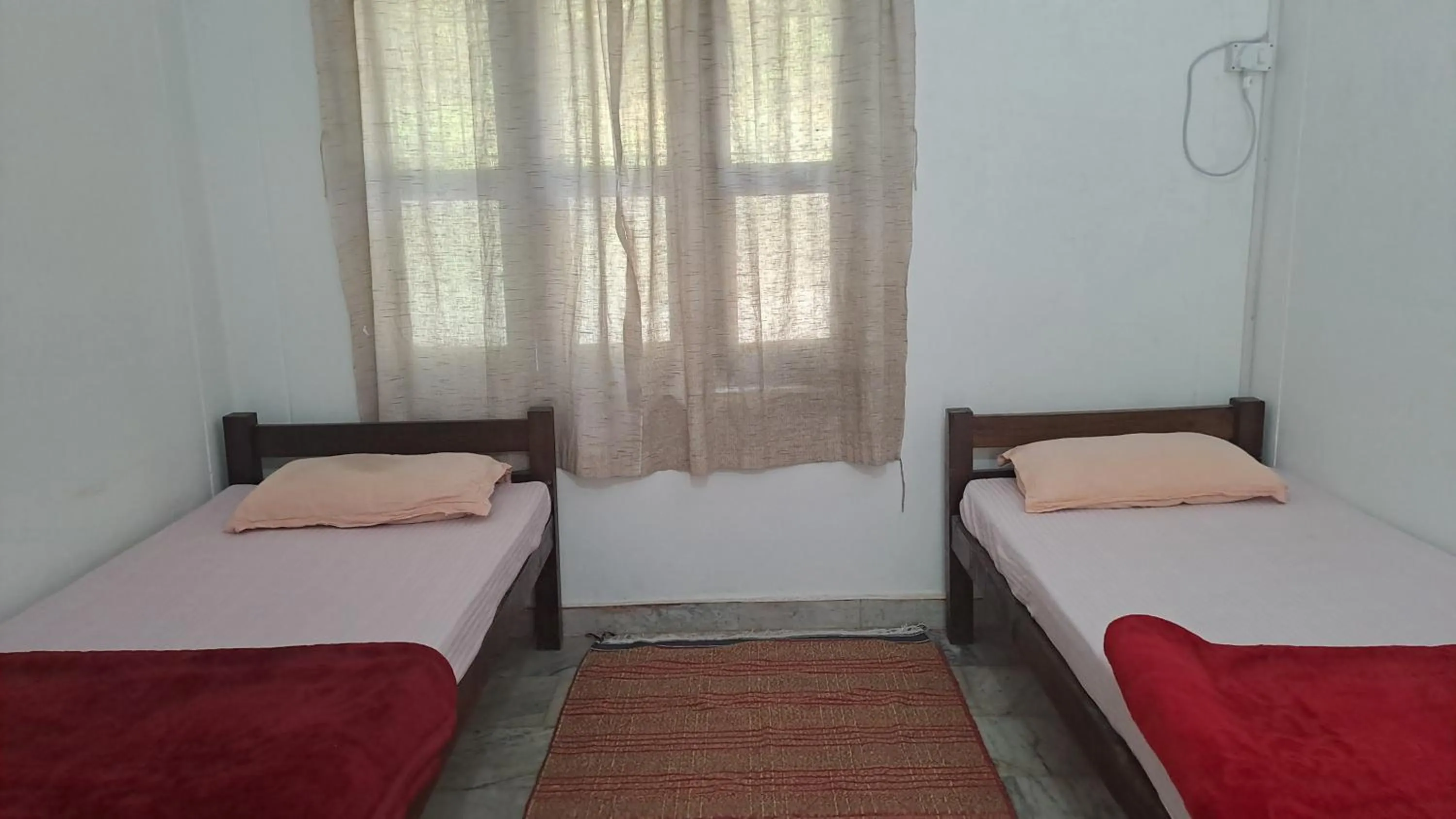 Photo of the whole room, Bed in Swami Samarpan Ashram
