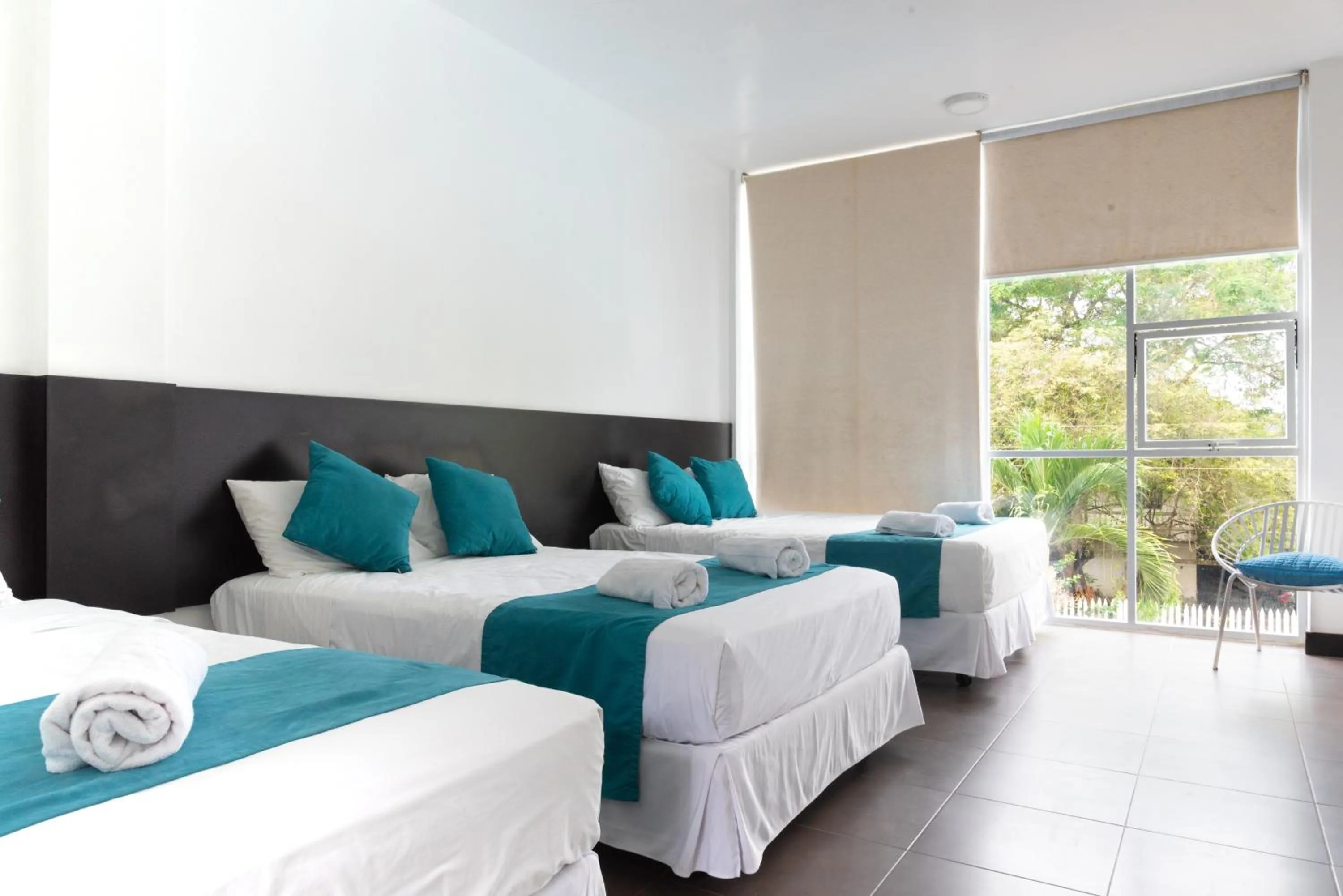 Photo of the whole room, Bed in Ocean Blue Hotel