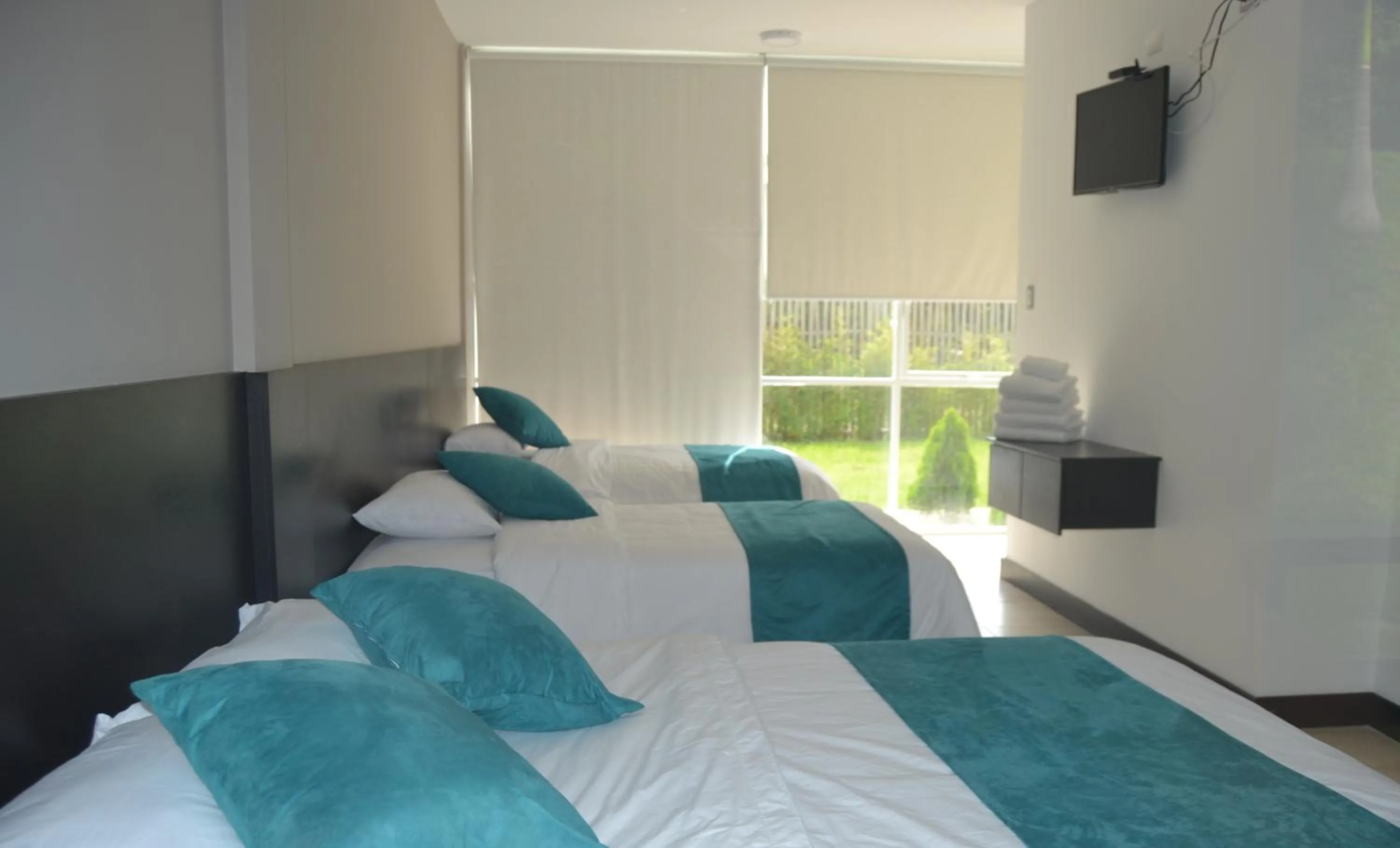 Photo of the whole room, Bed in Ocean Blue Hotel