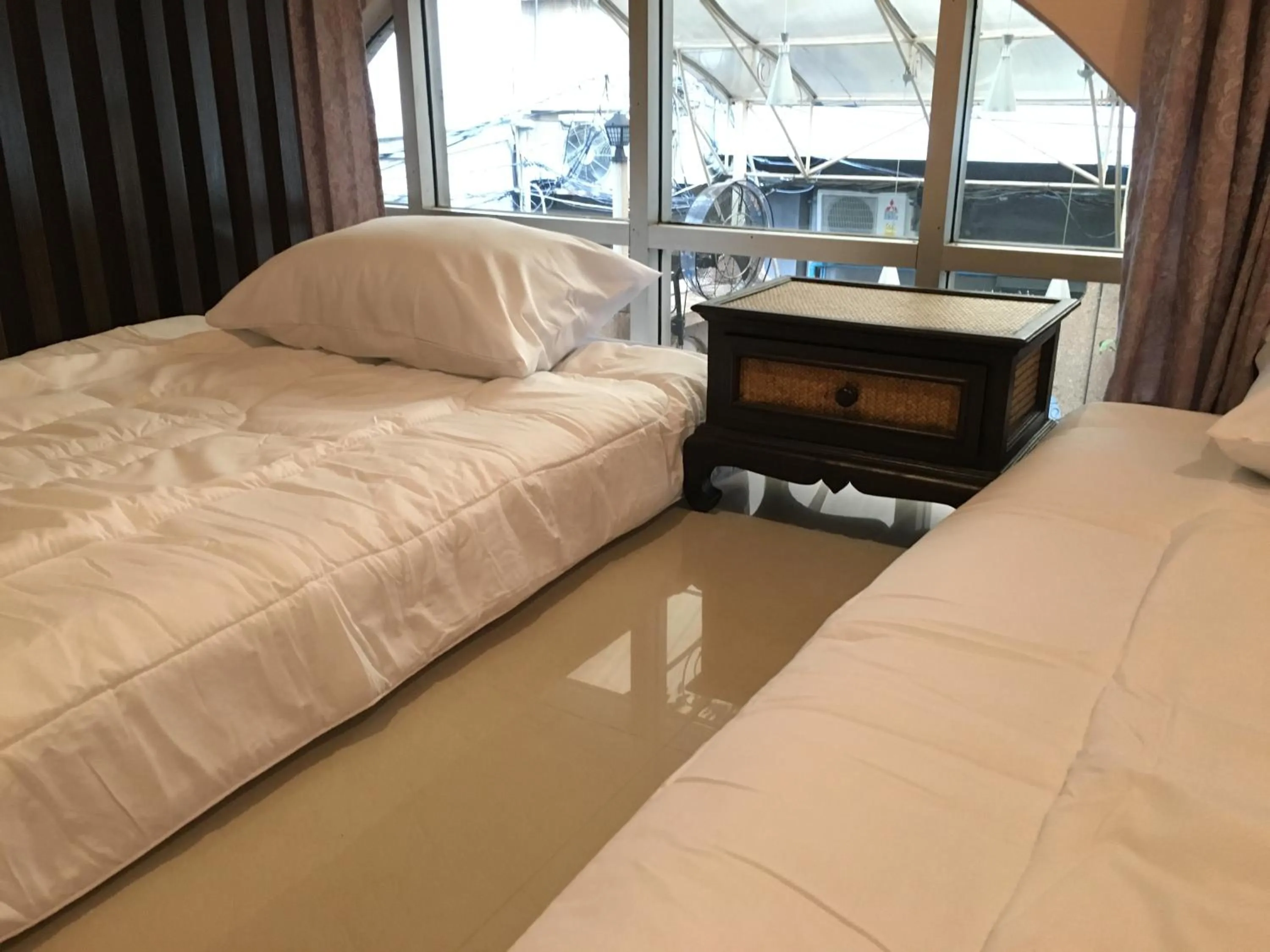 Bed in The Grand Palace Hotel