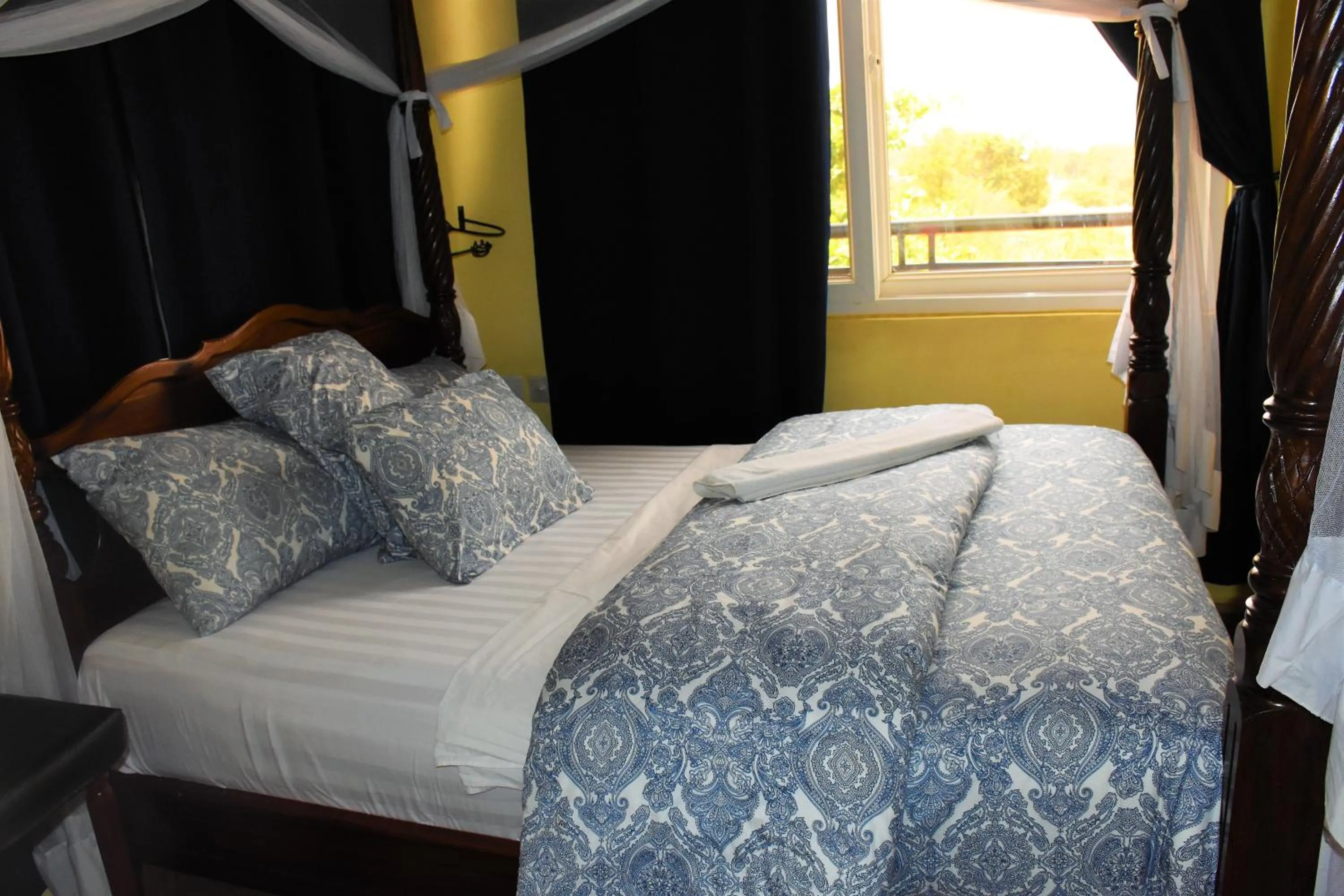 Bed in East Point Hotel Moshi