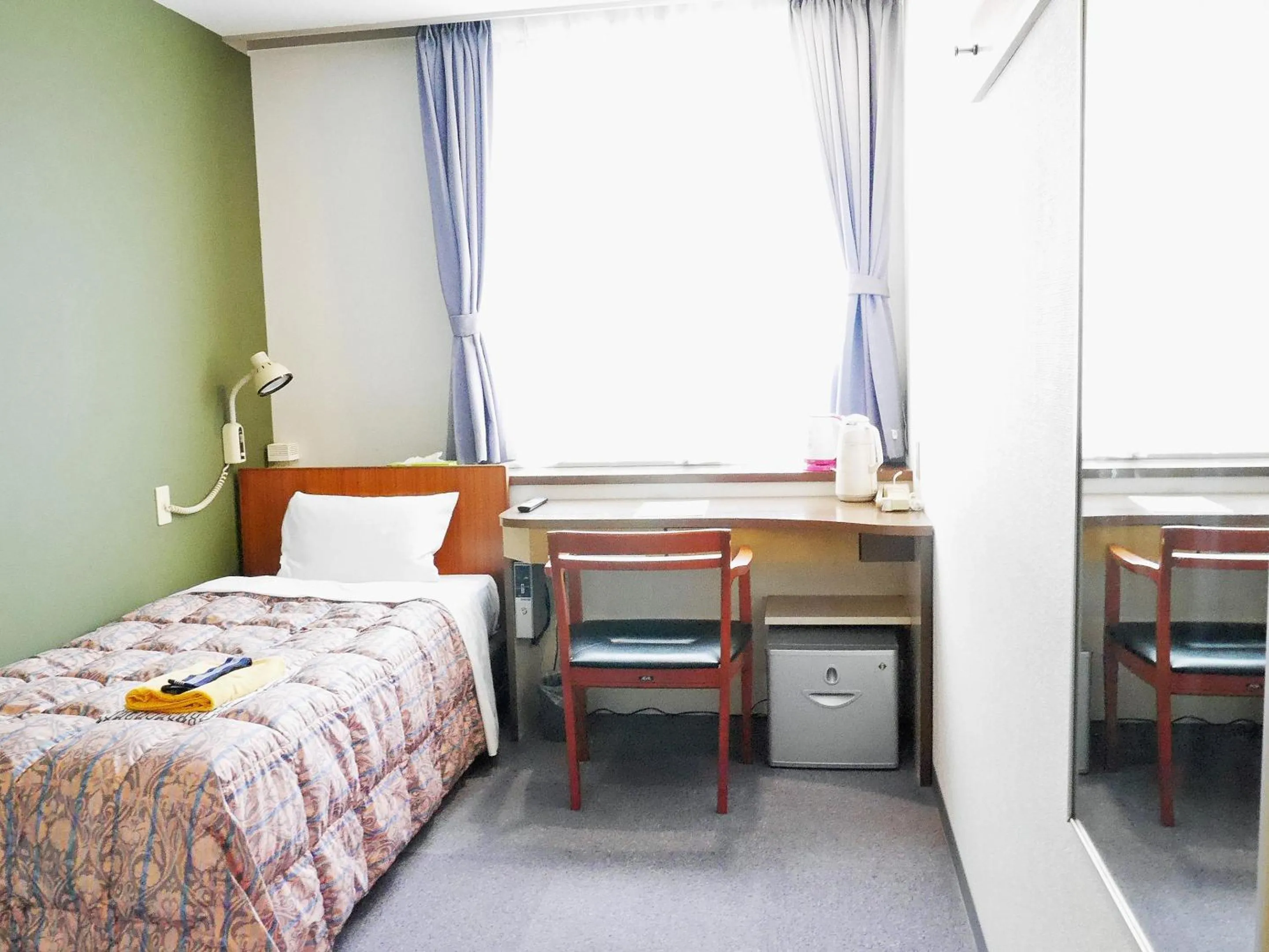 Bed in Station Business Hotel Tenshukaku