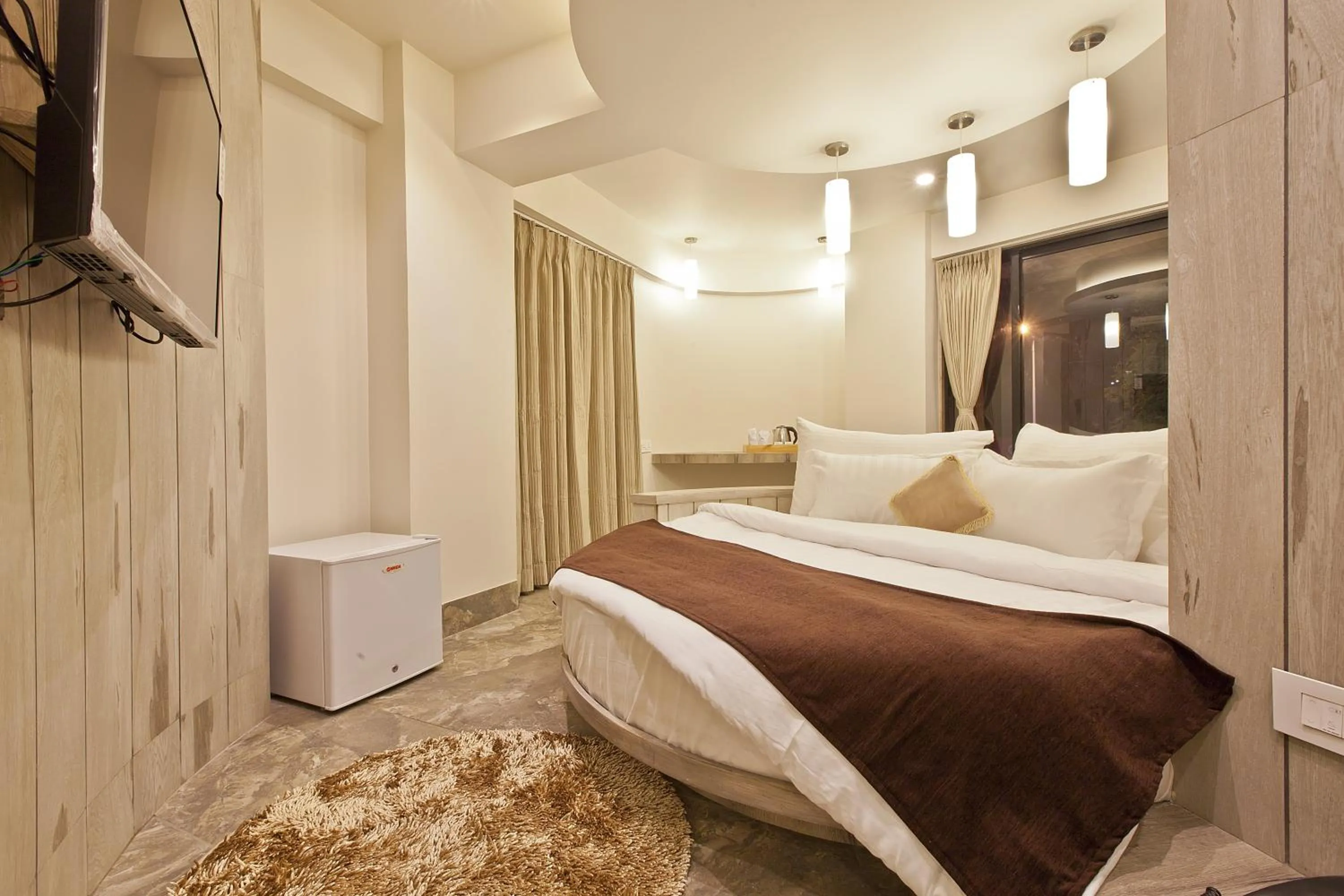 Photo of the whole room, Bed in Scenaria Hotel - Navrangpura, Ahmedabad