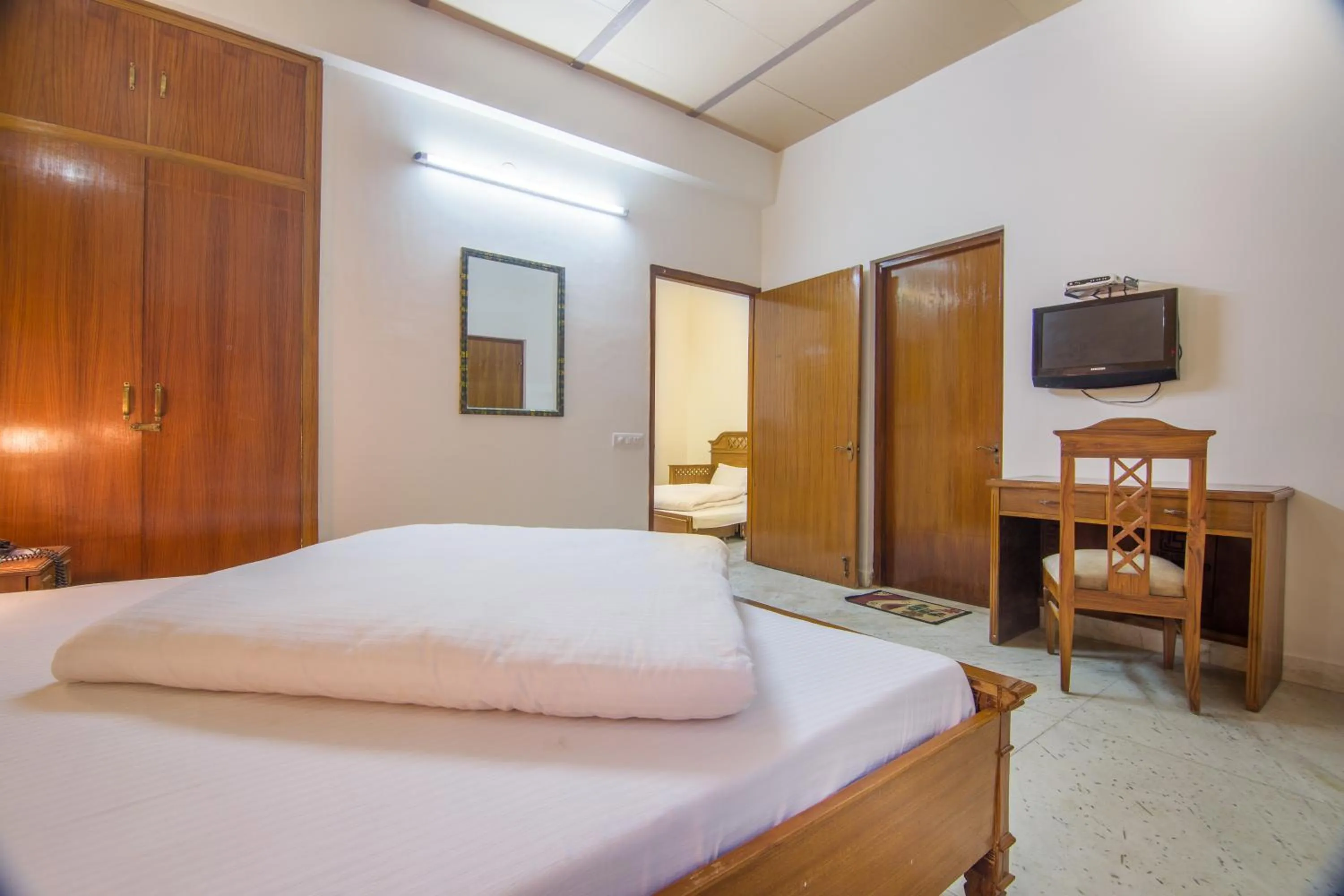 Bed in Hotel Bhakti Dhama