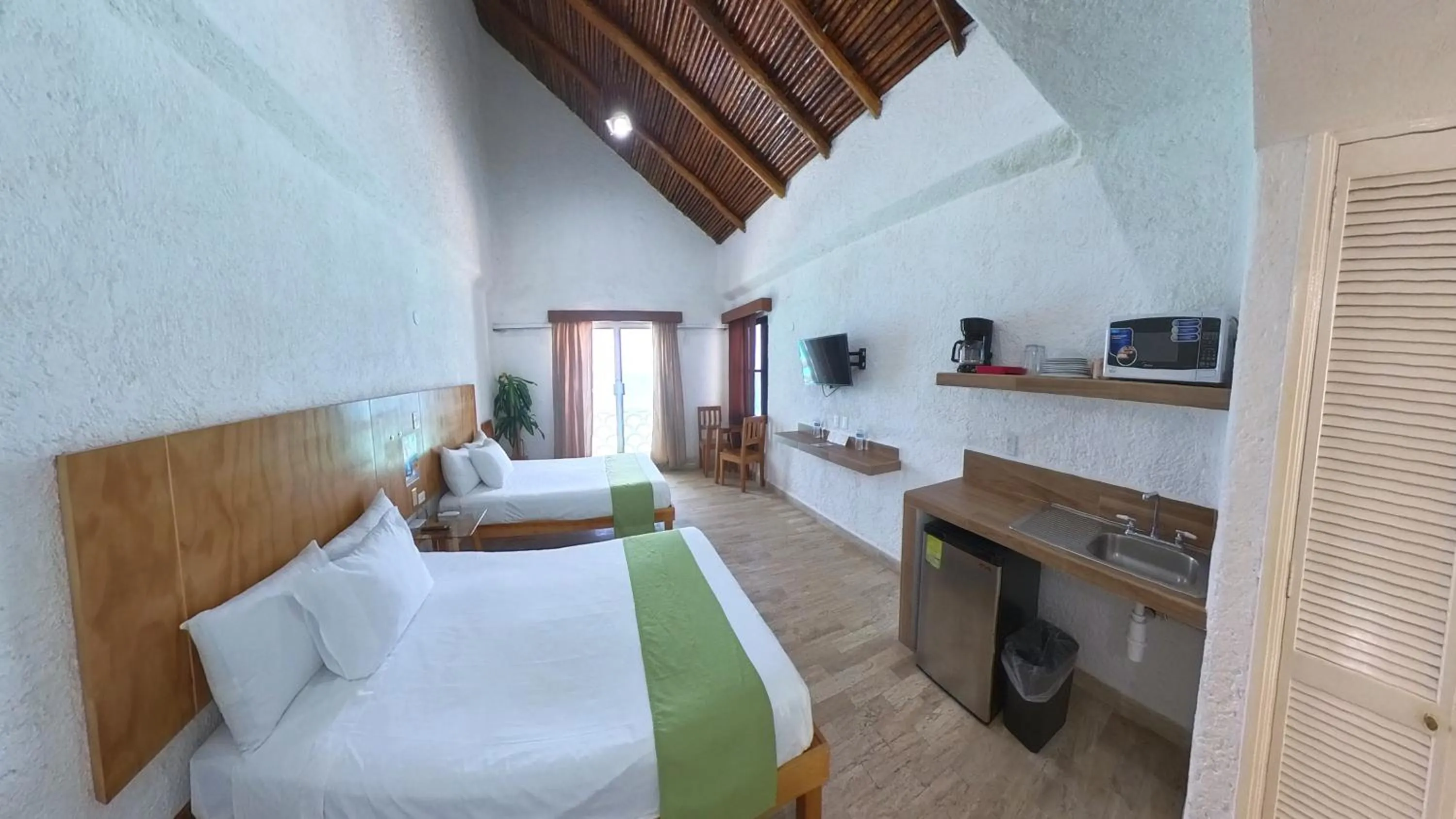 Bed in Cancún Plaza Sea View