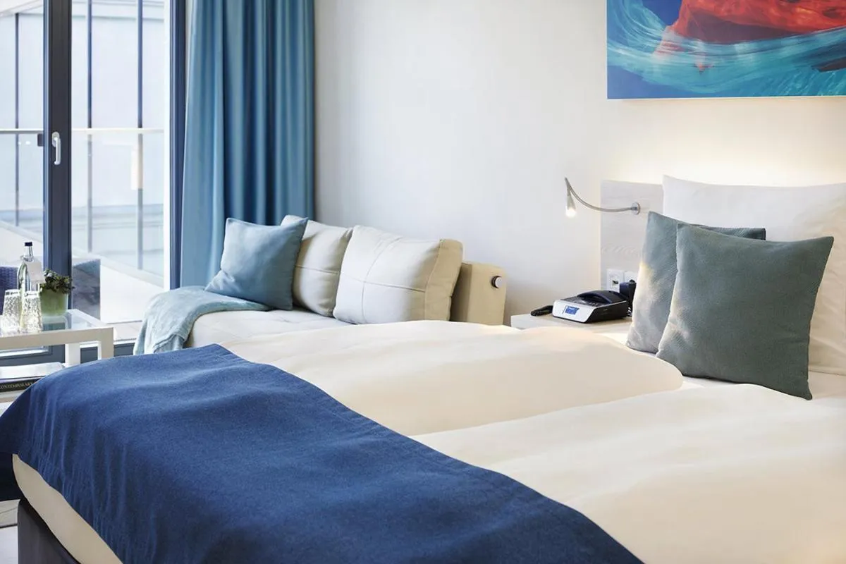 Photo of the whole room, Bed in SEETELHOTEL Kaiserstrand Beachhotel das Lifestyle-Hotel direkt am Strand