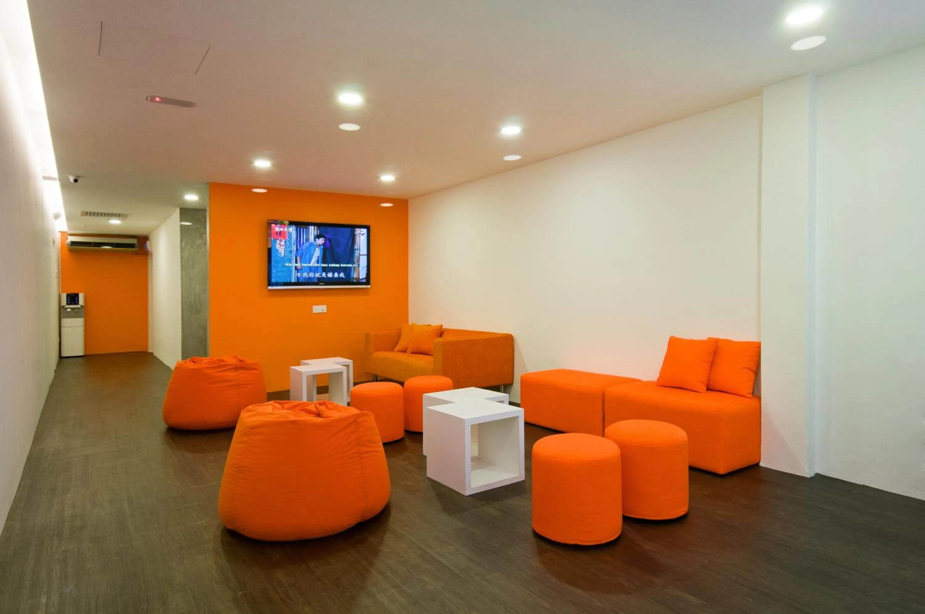 Communal lounge/ TV room in M Qube Hotel