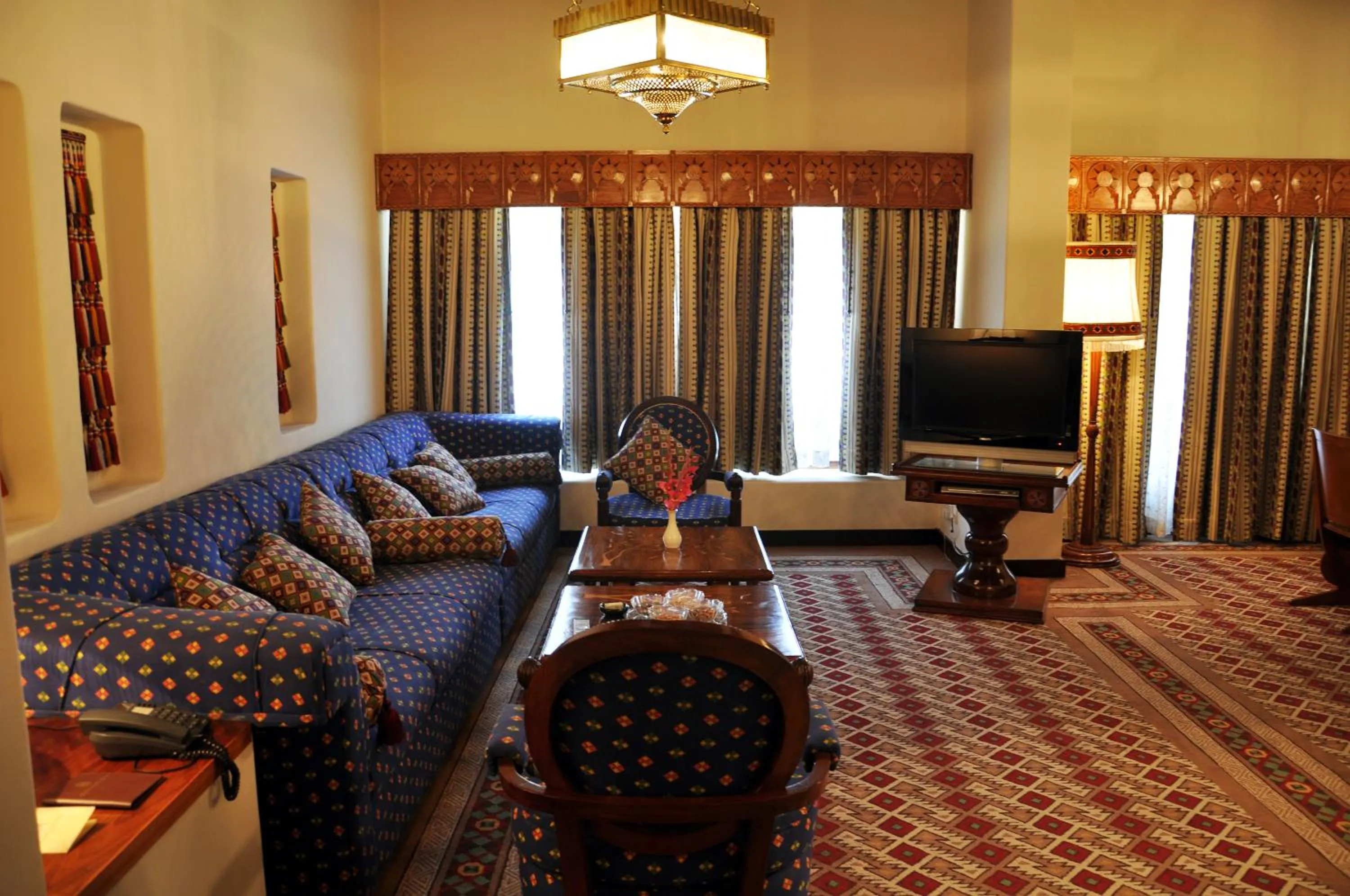 Communal lounge/ TV room, Bed in Quetta Serena Hotel