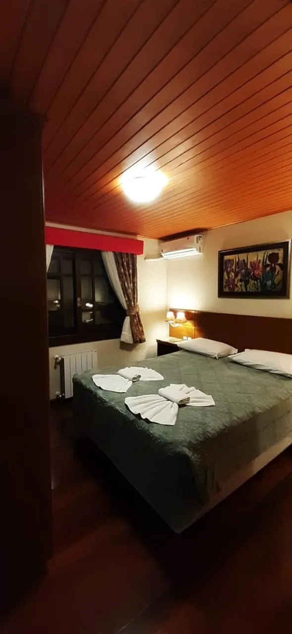 Bed in Pousada Das Papoulas