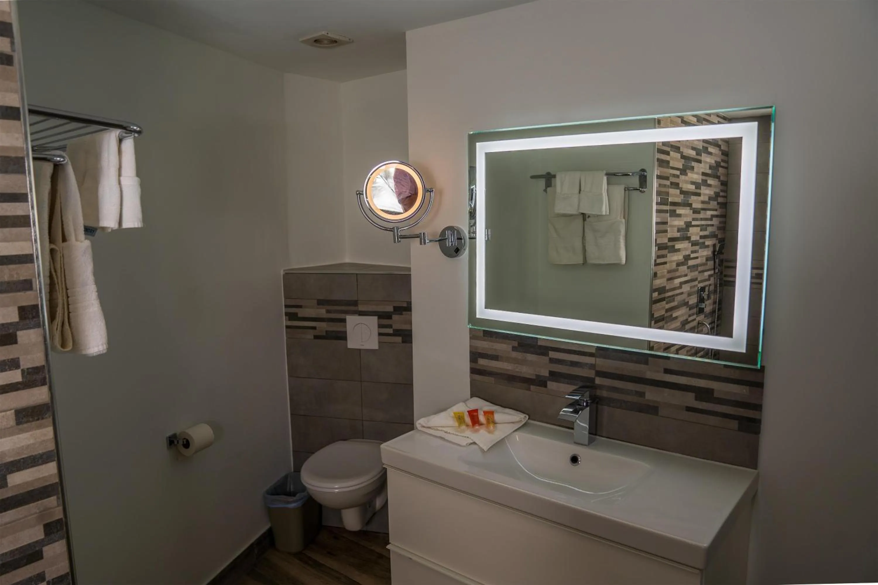 Bathroom in Commodore Suites, SureStay Collection by Best Western