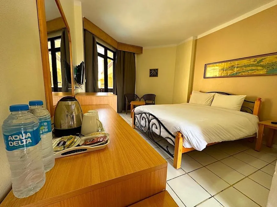 Bed in Gaddis Hotel, Suites and Apartments