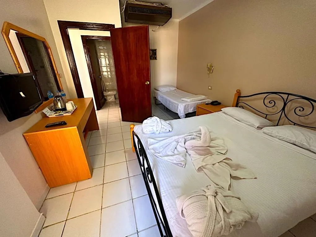 Bed in Gaddis Hotel, Suites and Apartments