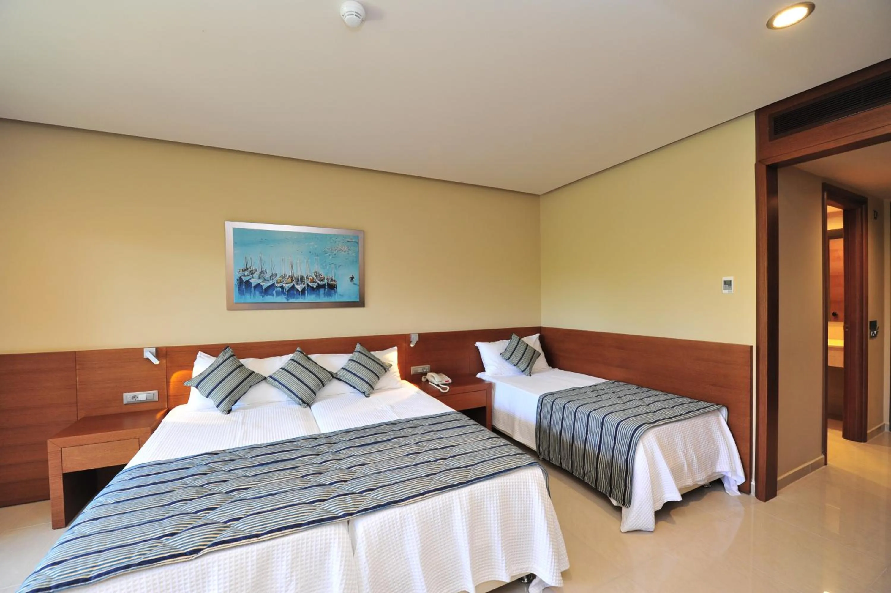 Bed in Apollonion Asterias Resort and Spa