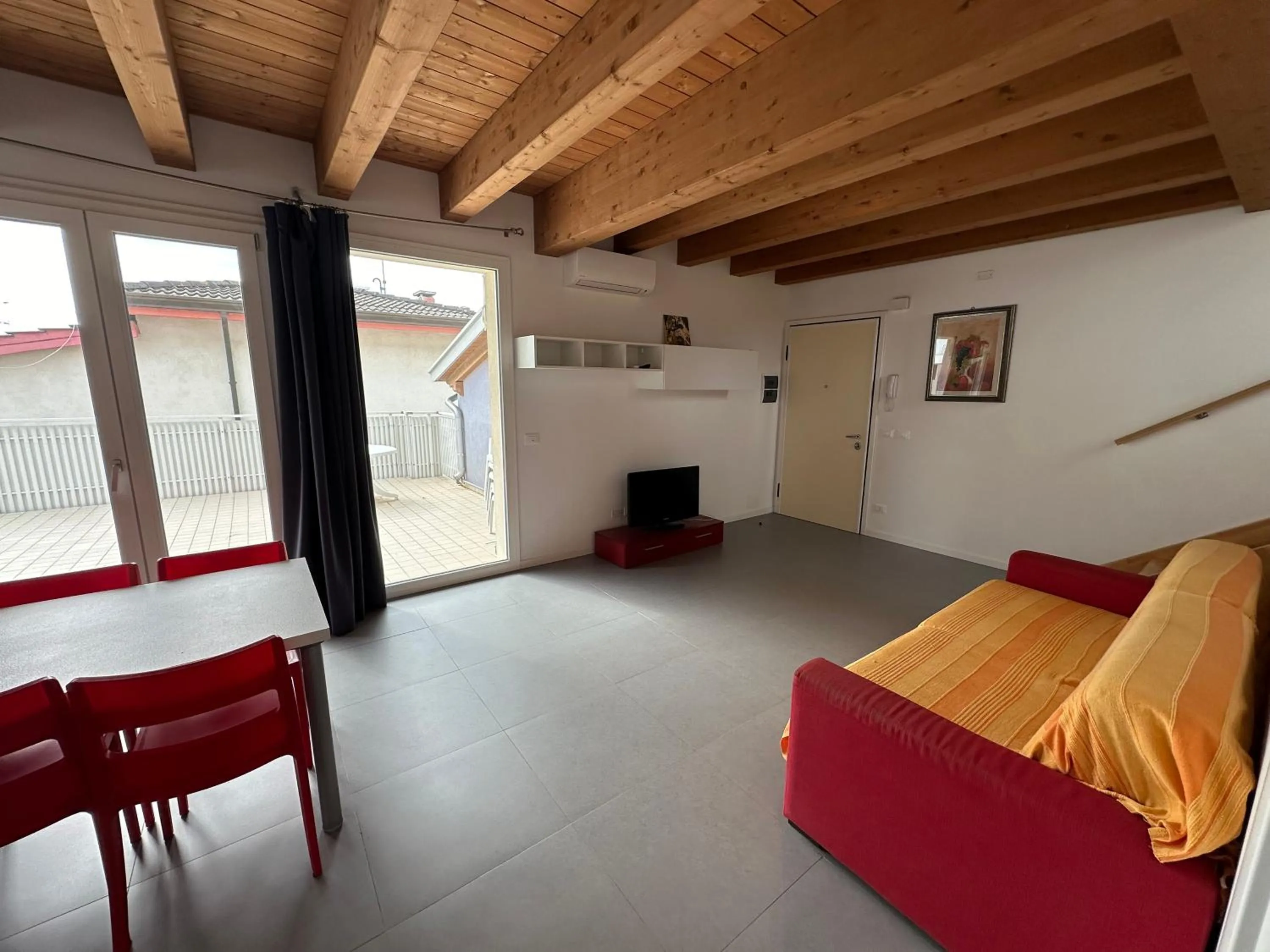 Living room, Bed in Attico Concordia - Agenzia Cocal