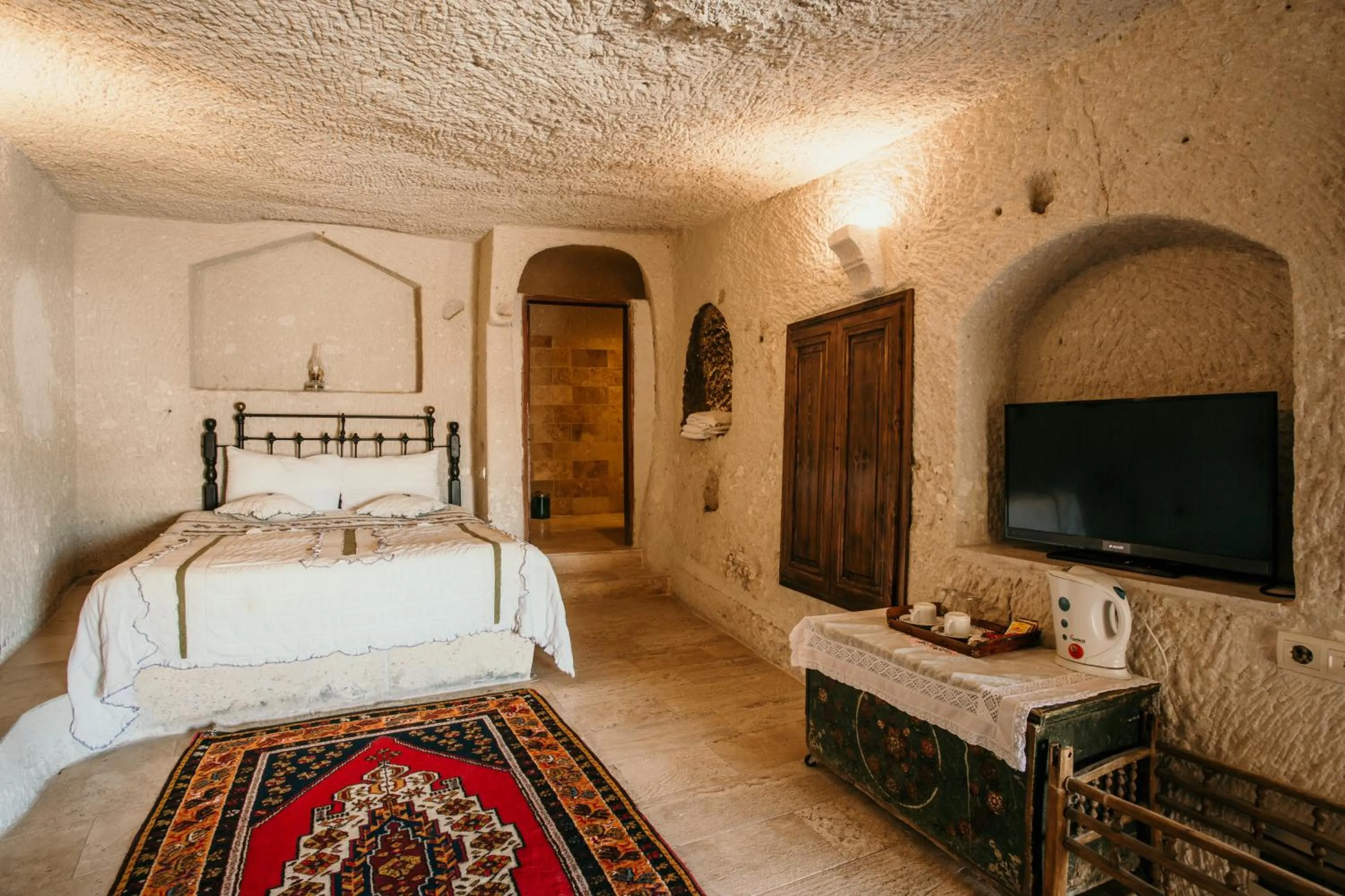 Bed in Village Cave House Hotel