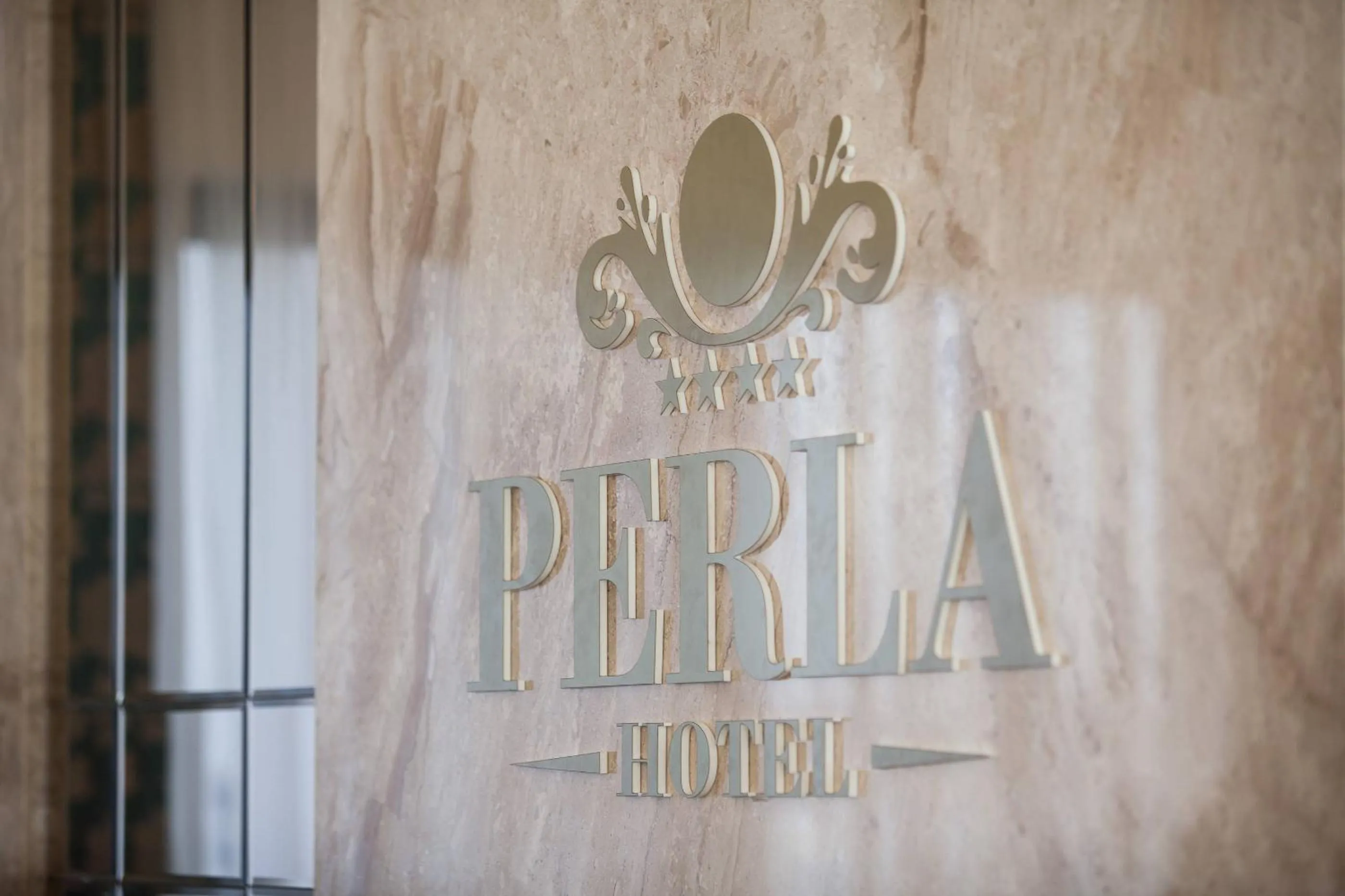 Property logo or sign in Hotel Perla