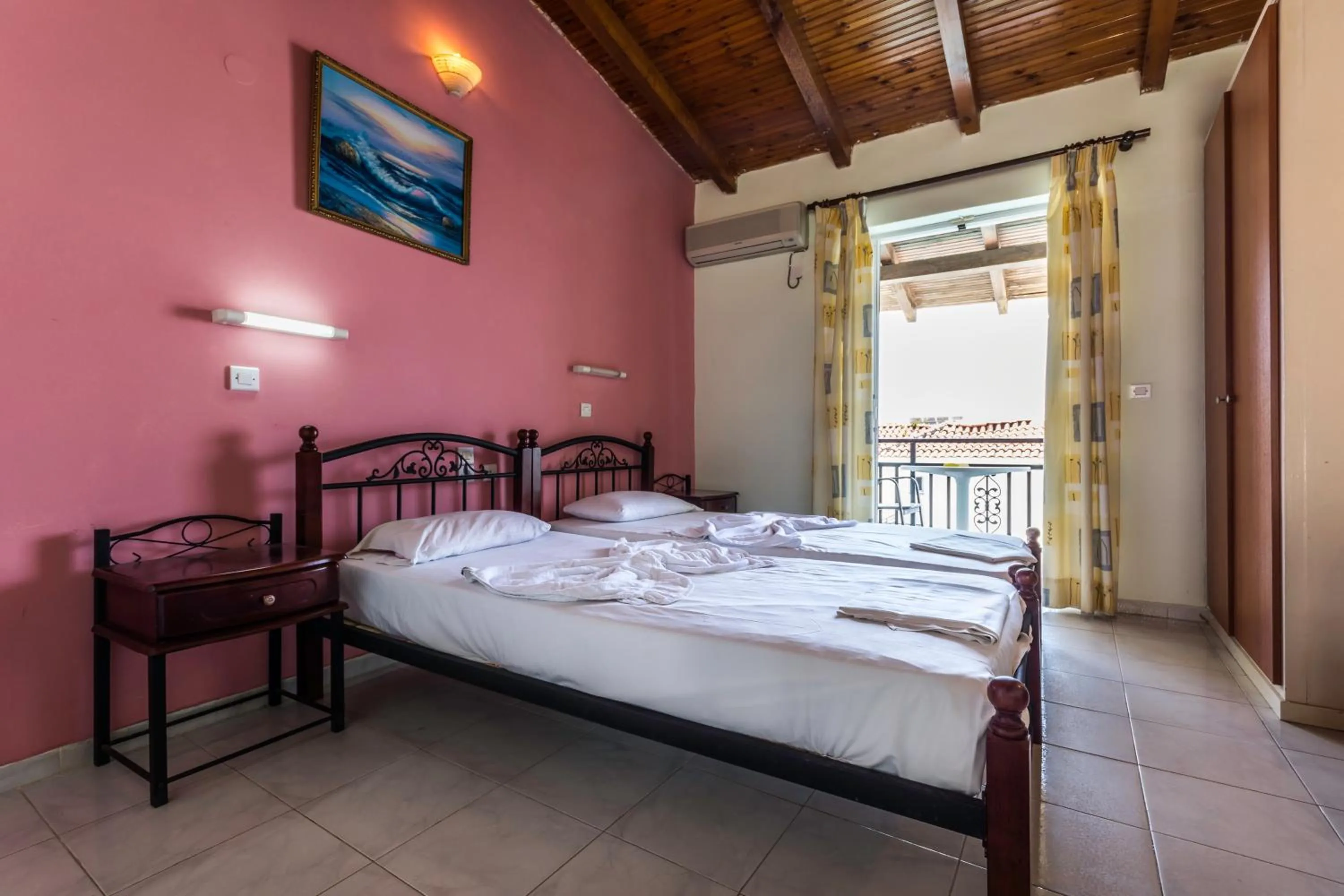 Bed in Vossos Hotel Apartments