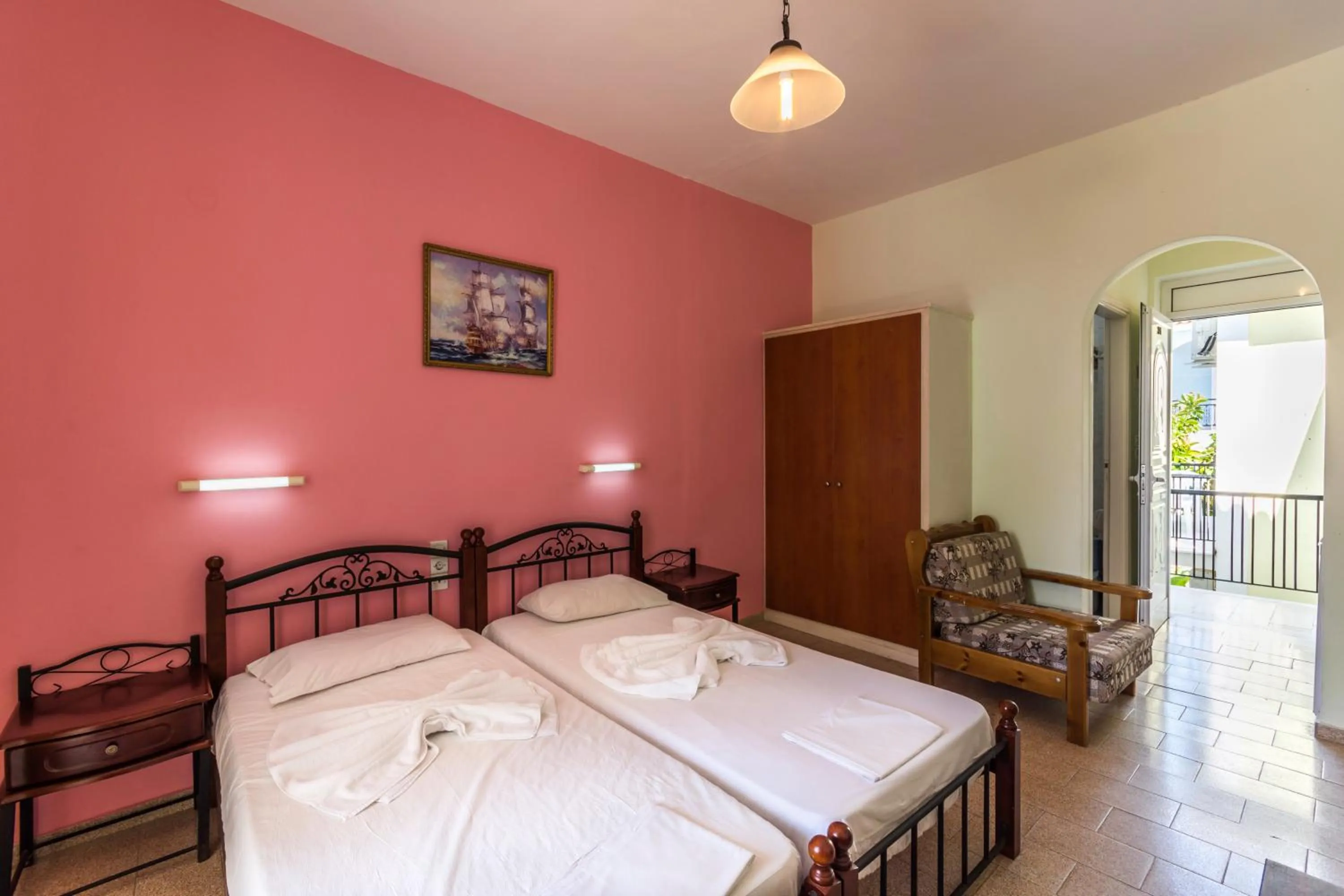 Bed in Vossos Hotel Apartments