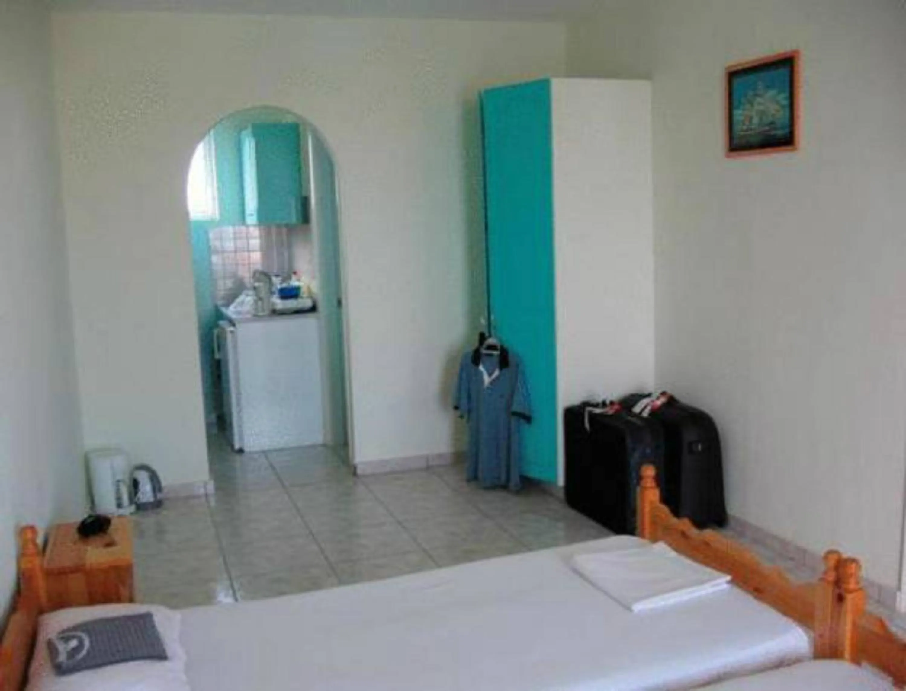 Bed in Vossos Hotel Apartments