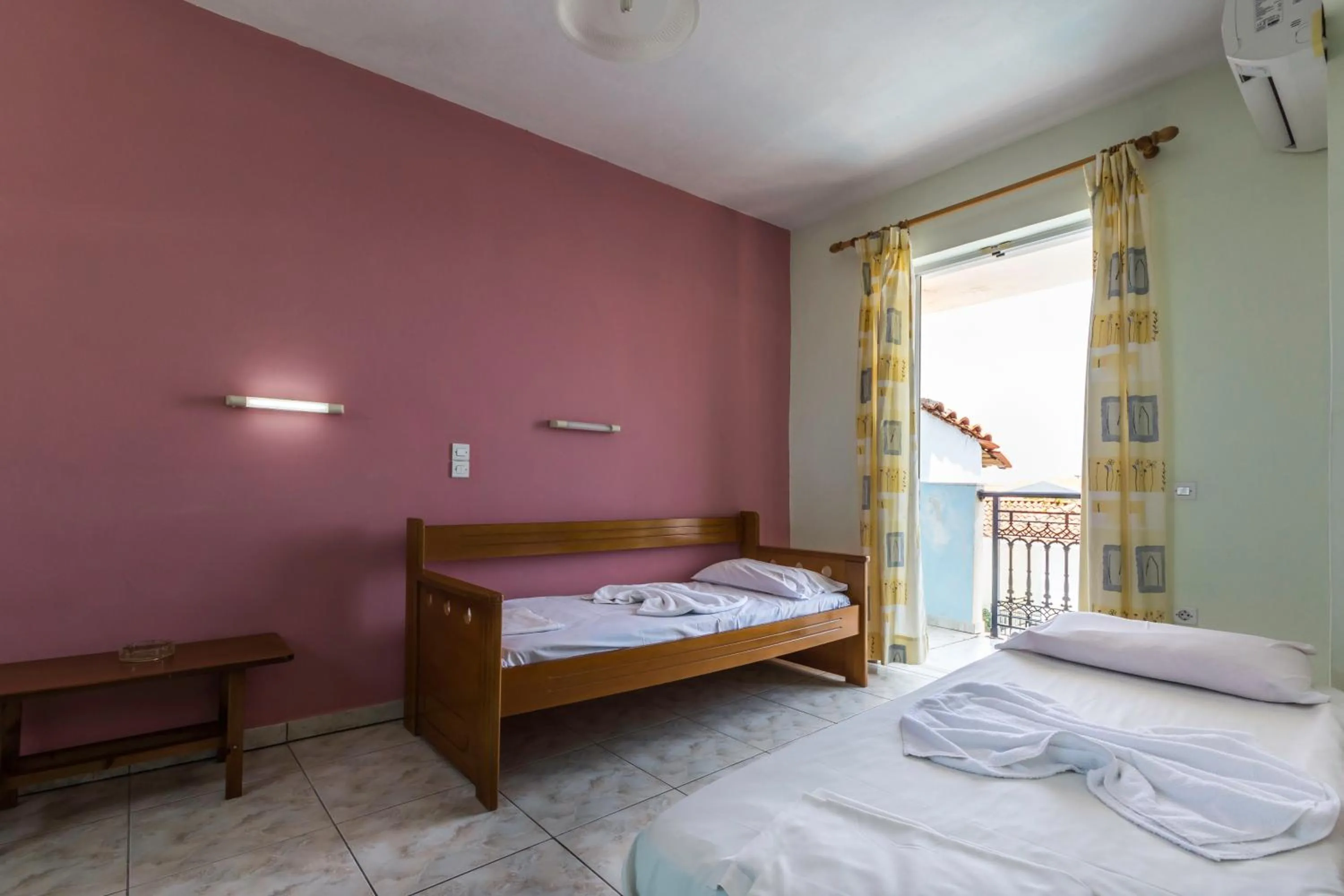 Bed in Vossos Hotel Apartments