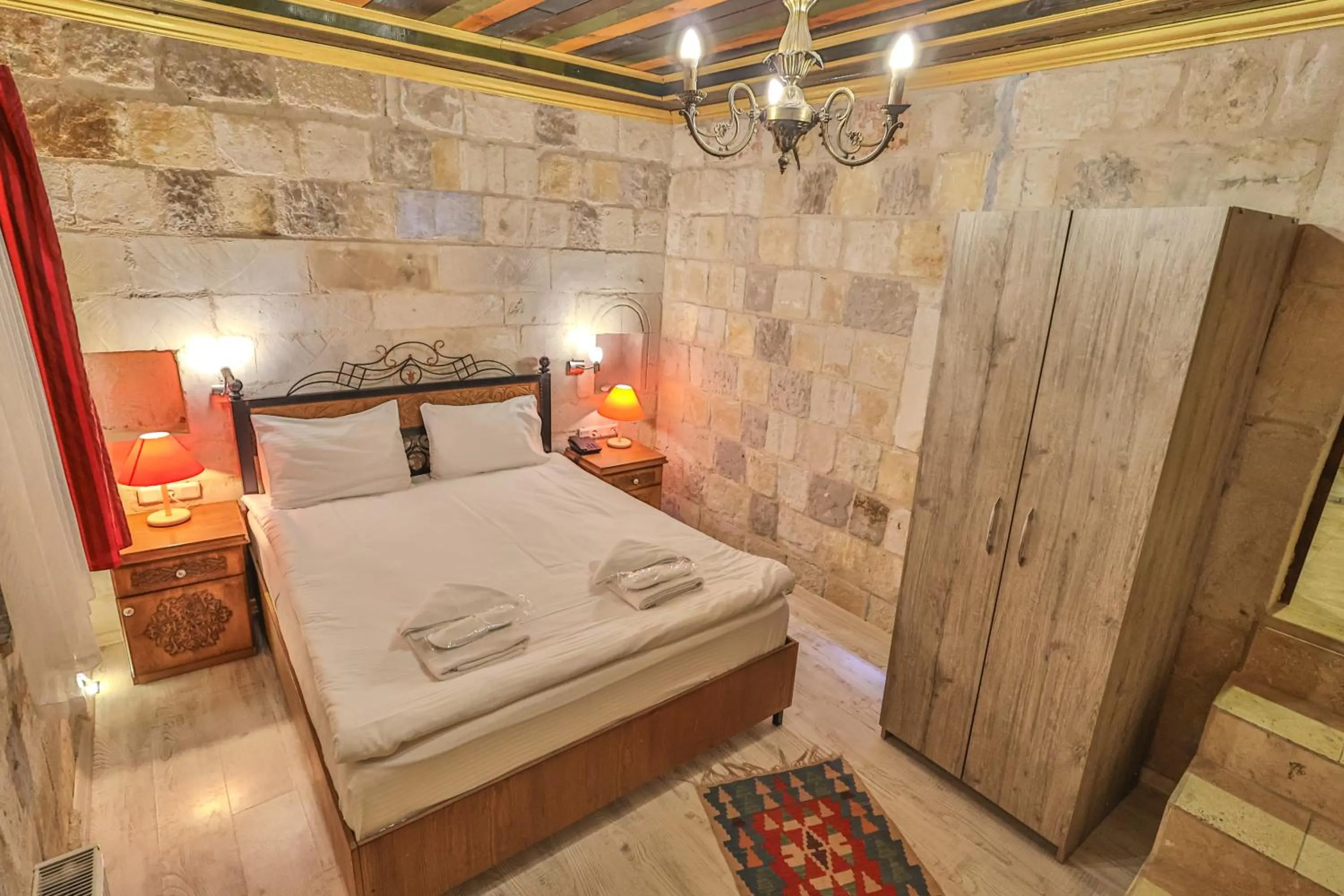 Photo of the whole room, Bed in Bedrock Cave Hotel