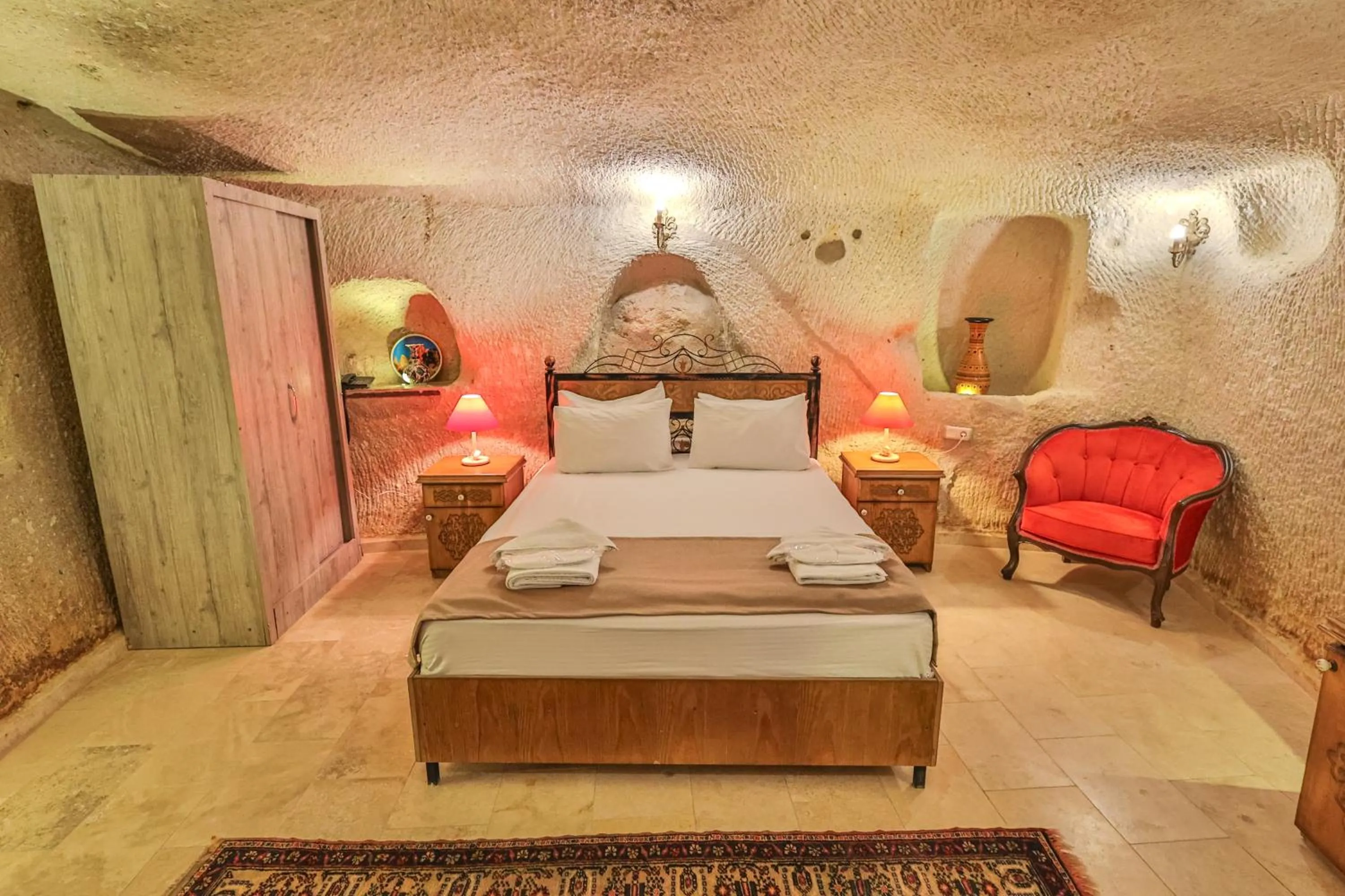 Living room, Bed in Bedrock Cave Hotel