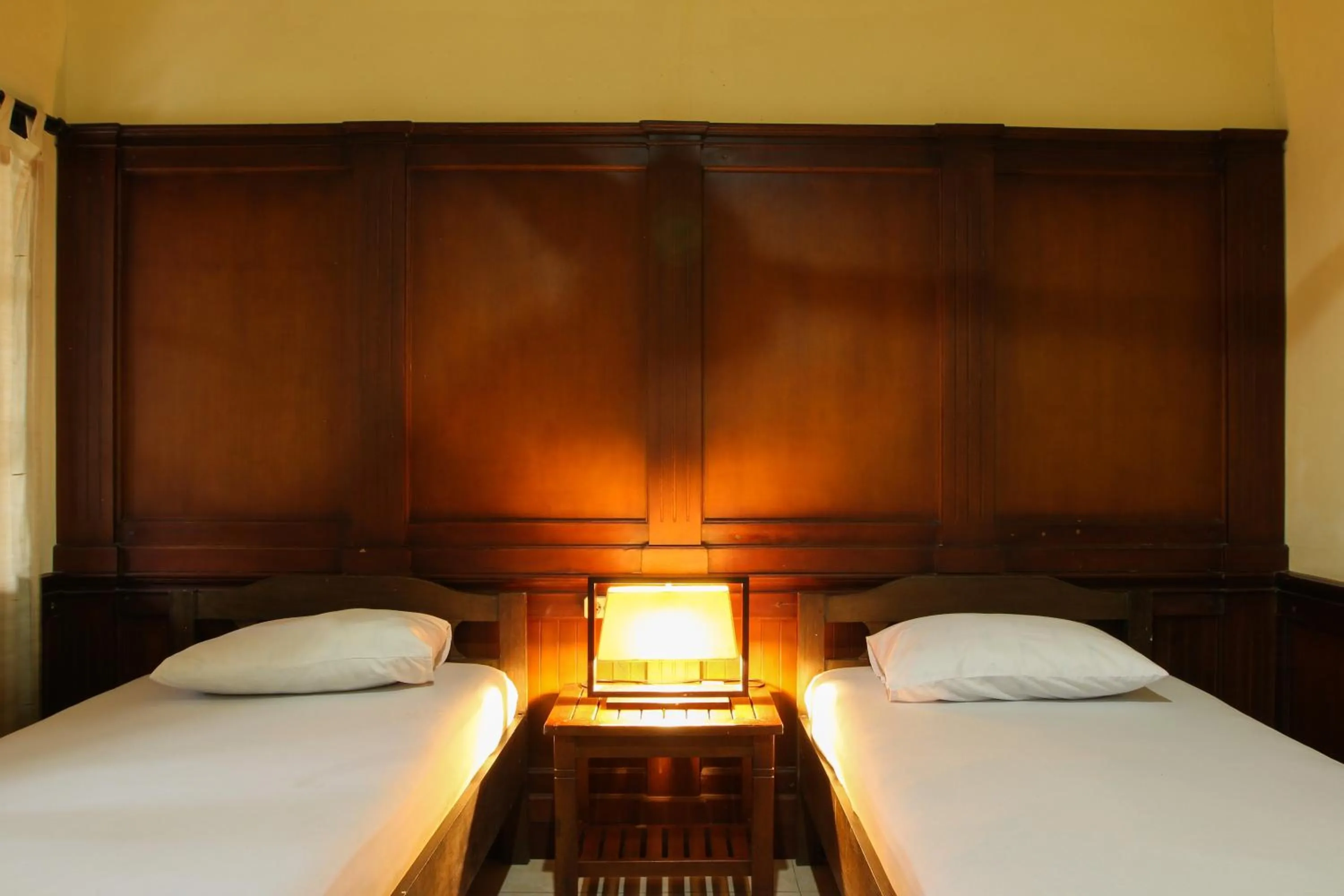 Bed in Sari Indah Cottages