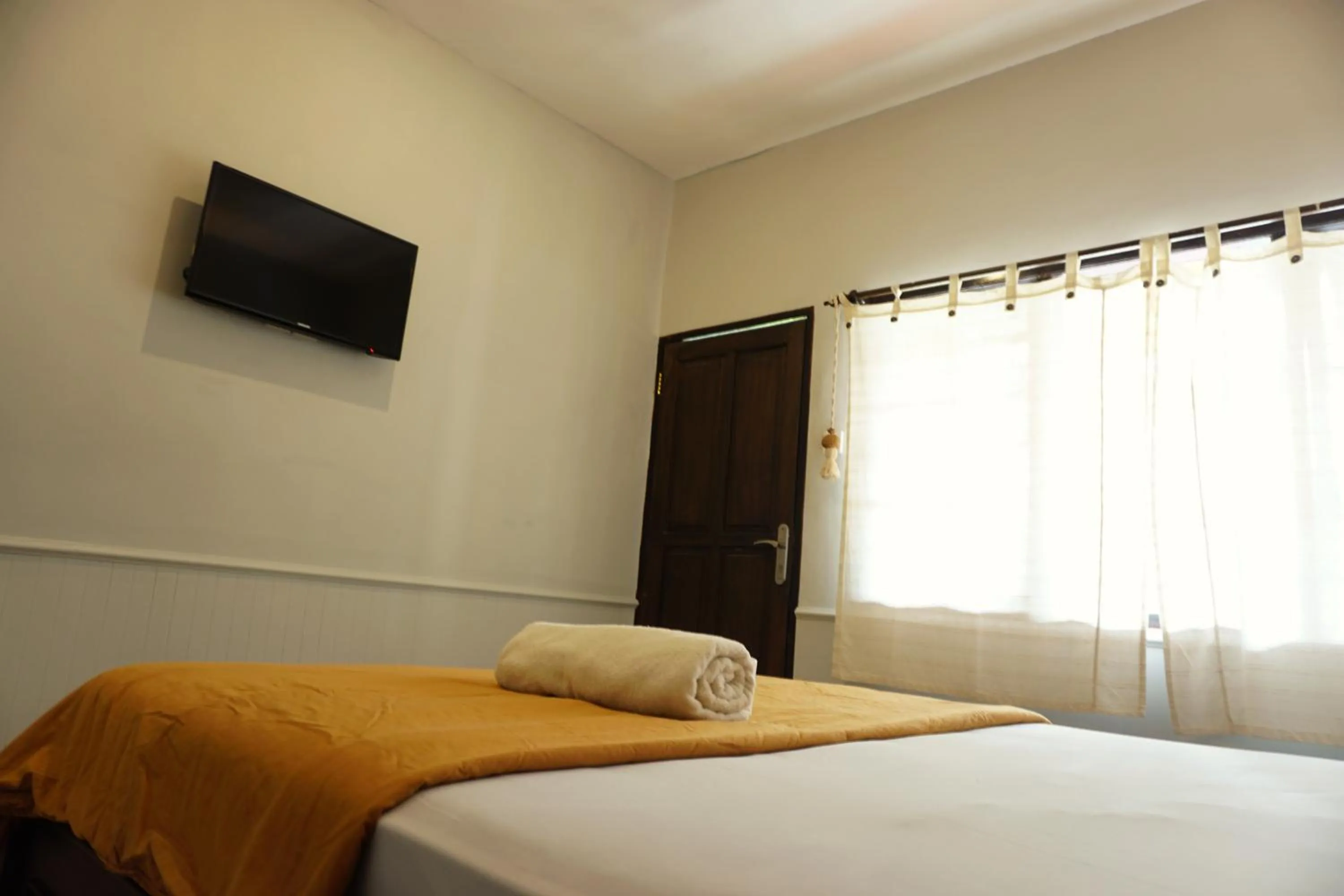 Bed in Sari Indah Cottages