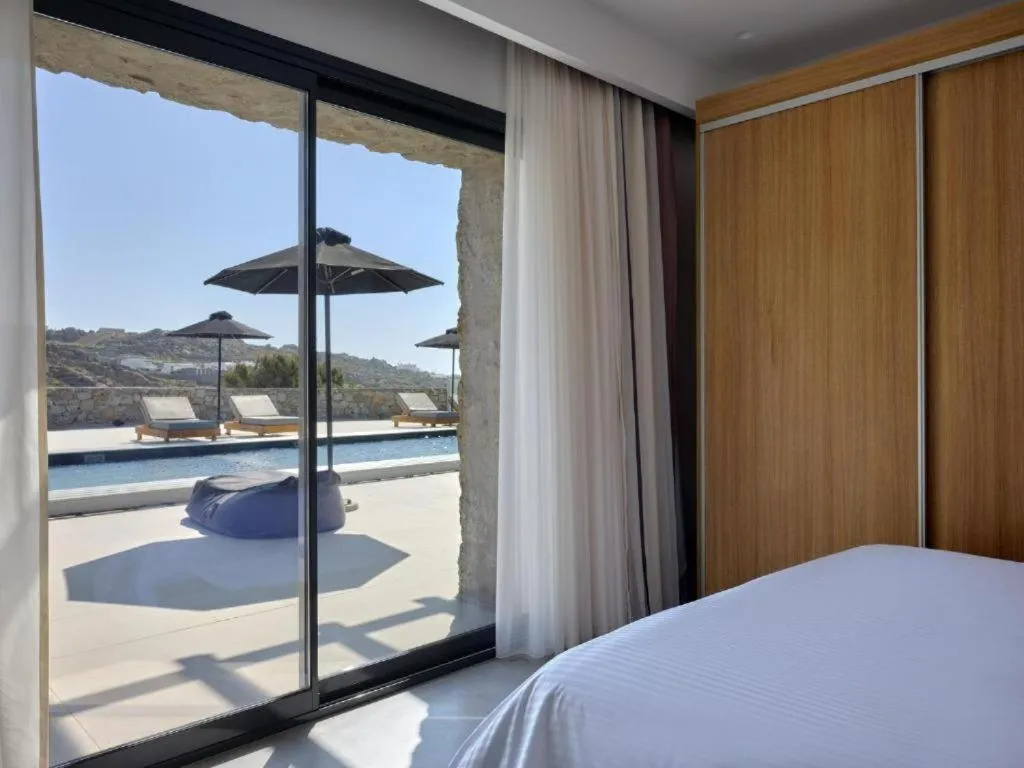Bed in Mykonos Kosmoplaz Beach Resort Hotel