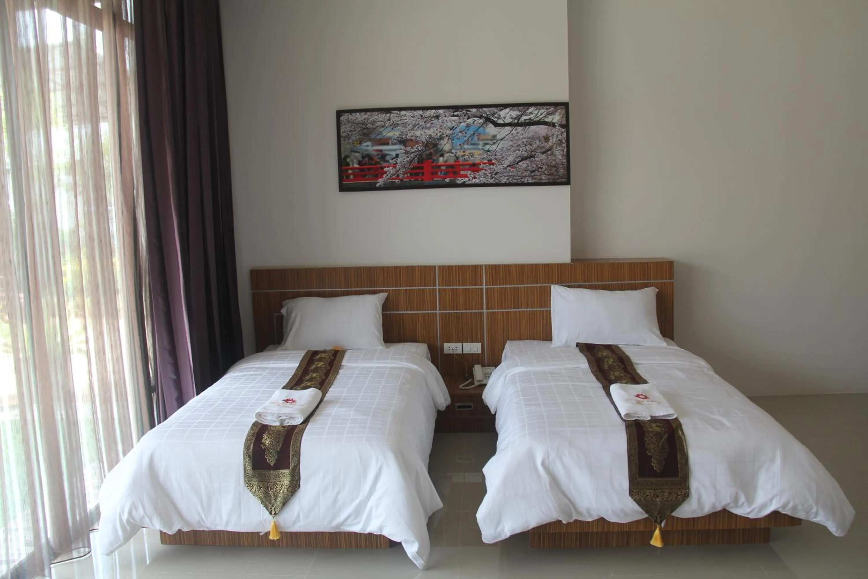 Bed in Tawan Anda Garden Hotel