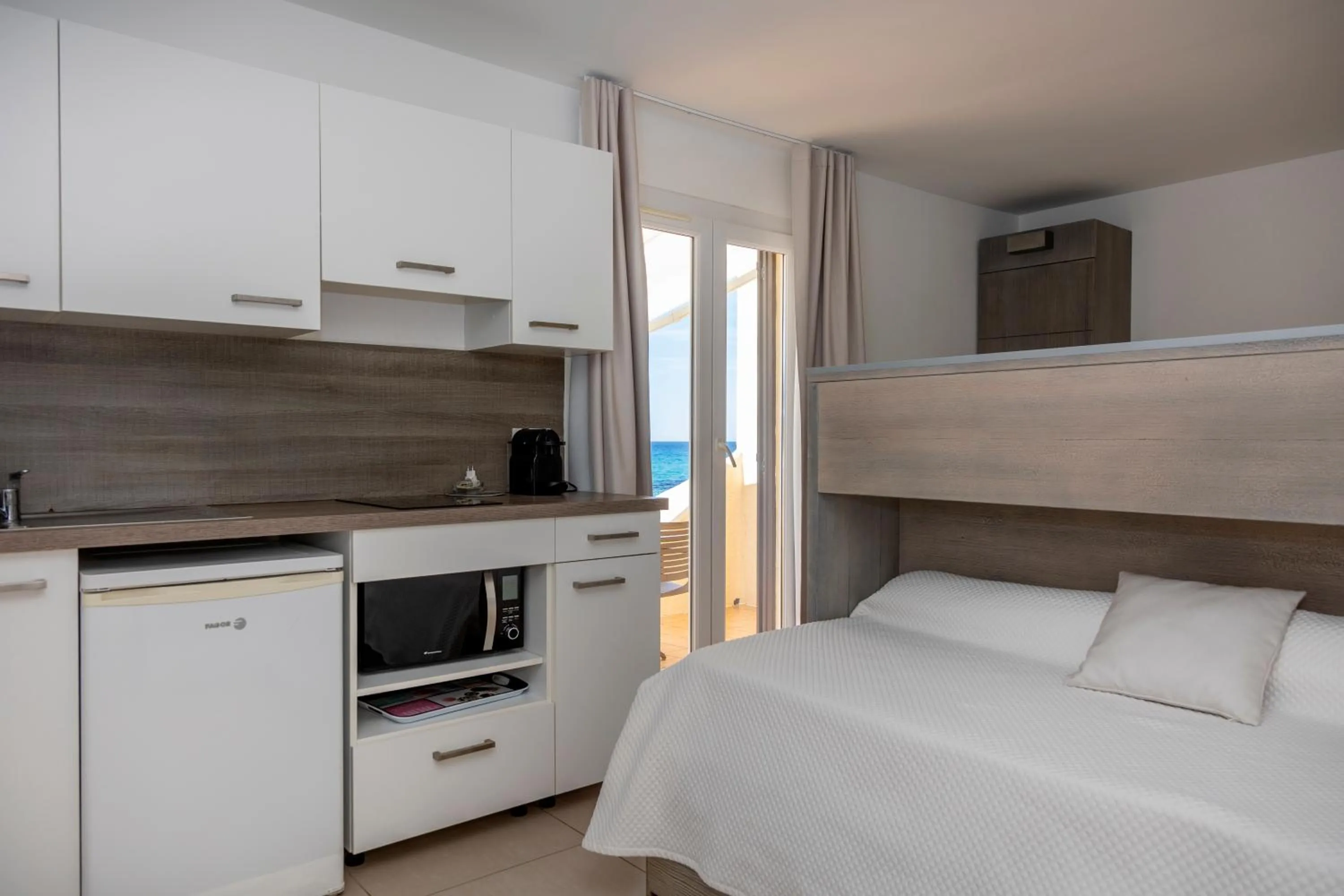 Kitchen or kitchenette, Bed in Hôtel et Résidence Ta Kladia - Omigna