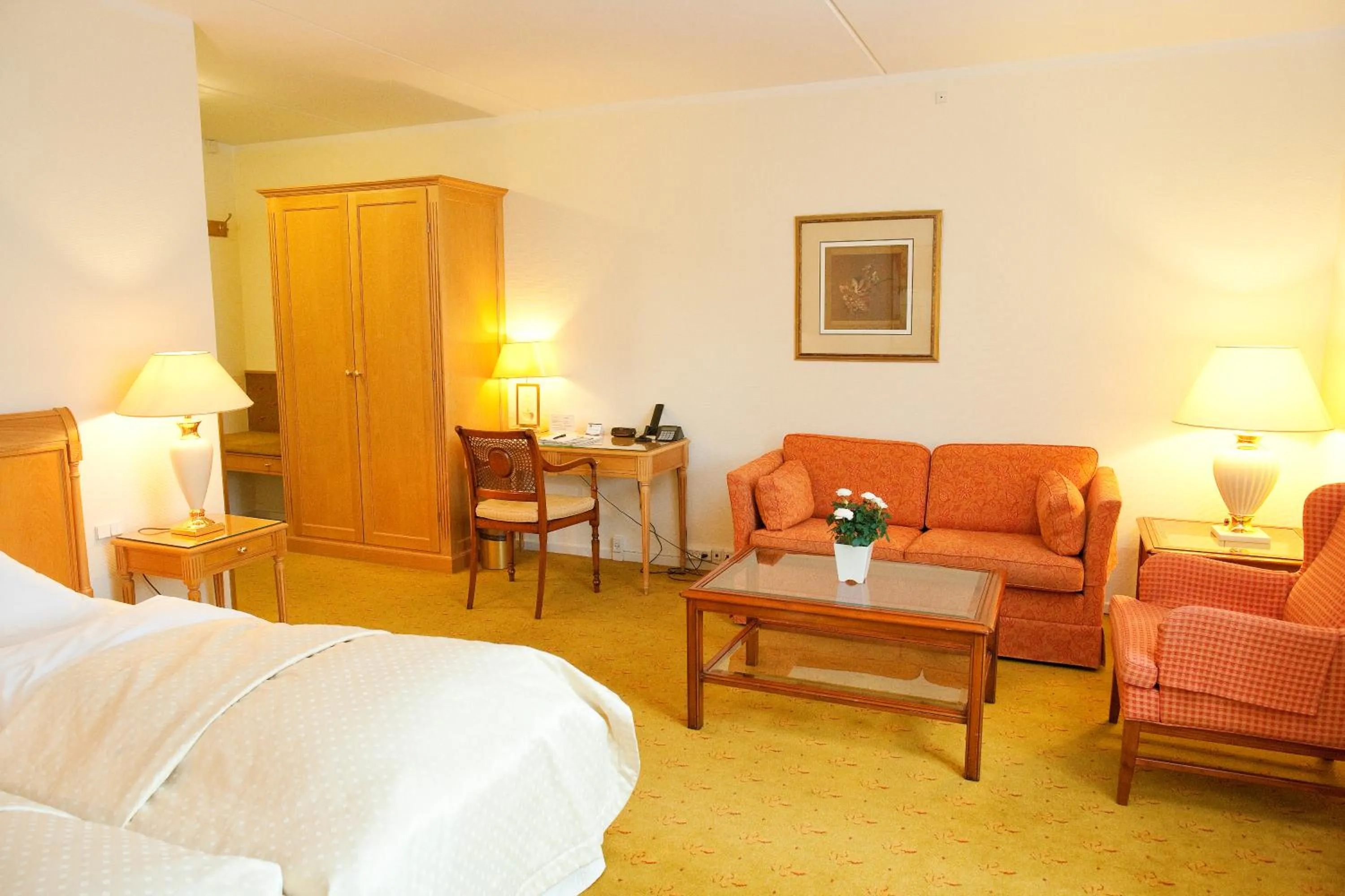 Seating area, Bed in Hotel Knudsens Gaard