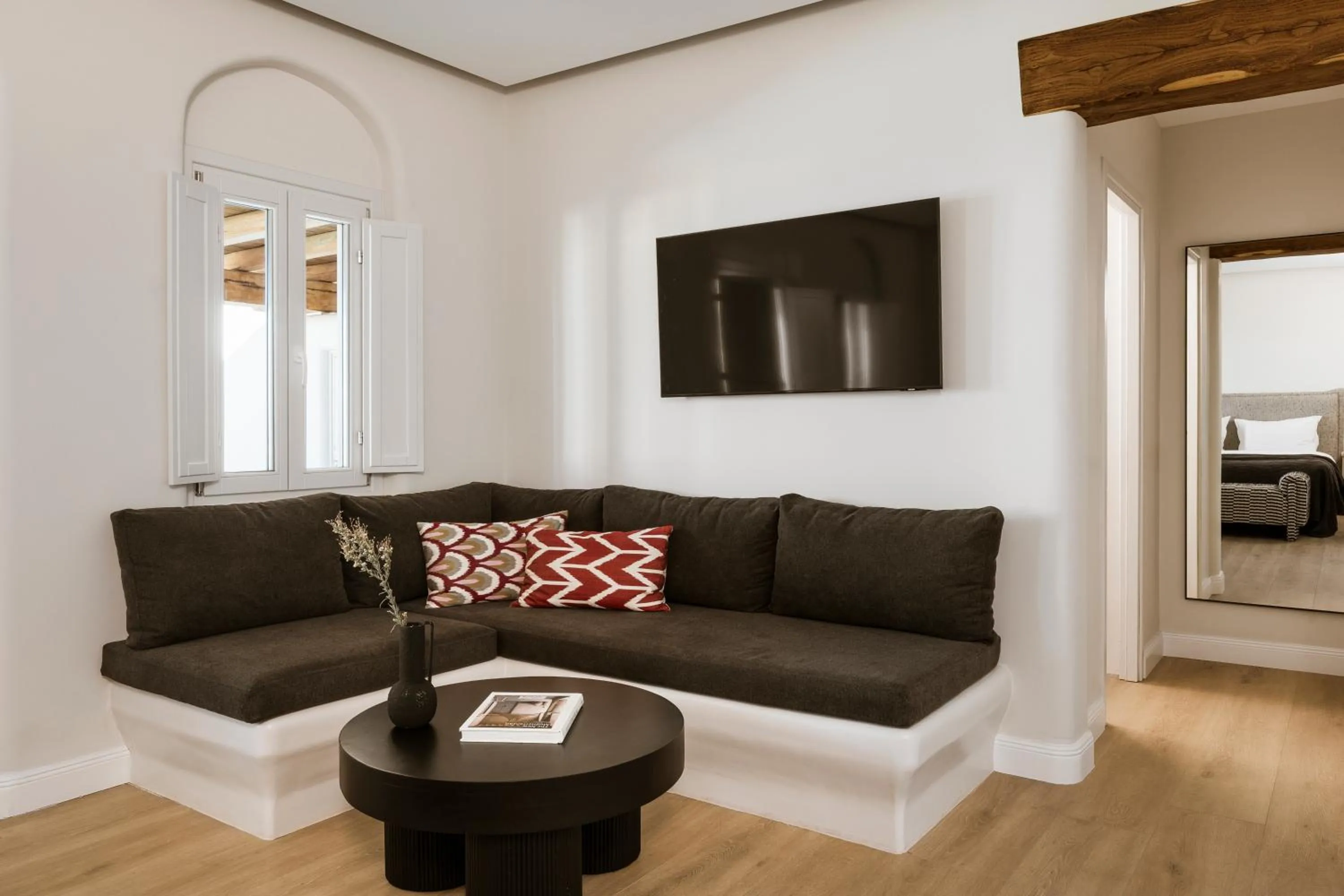 Seating area in NĒRO Suites by NOMÉE Hospitality Group