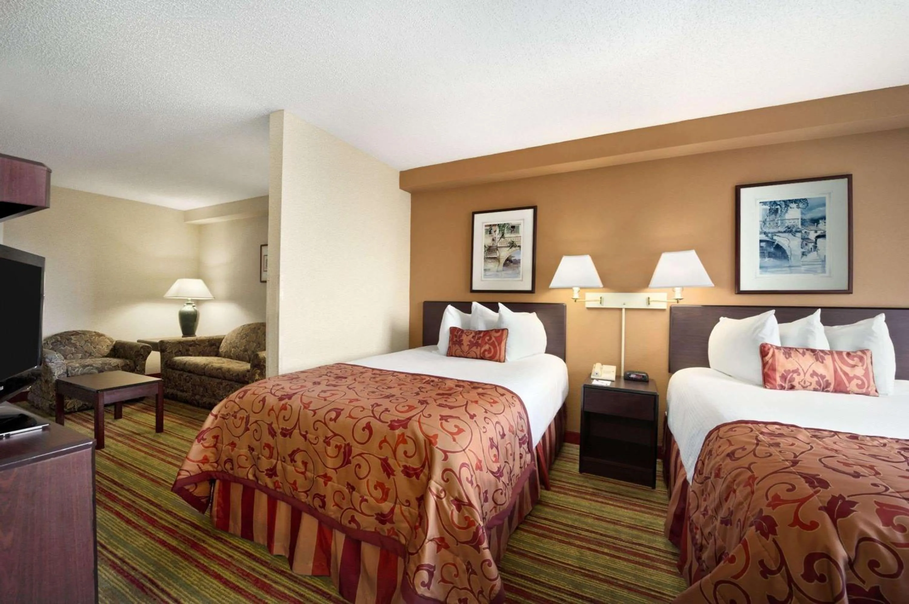 Photo of the whole room, Bed in Ramada by Wyndham Suites Orlando Airport- Free Airport Shuttle