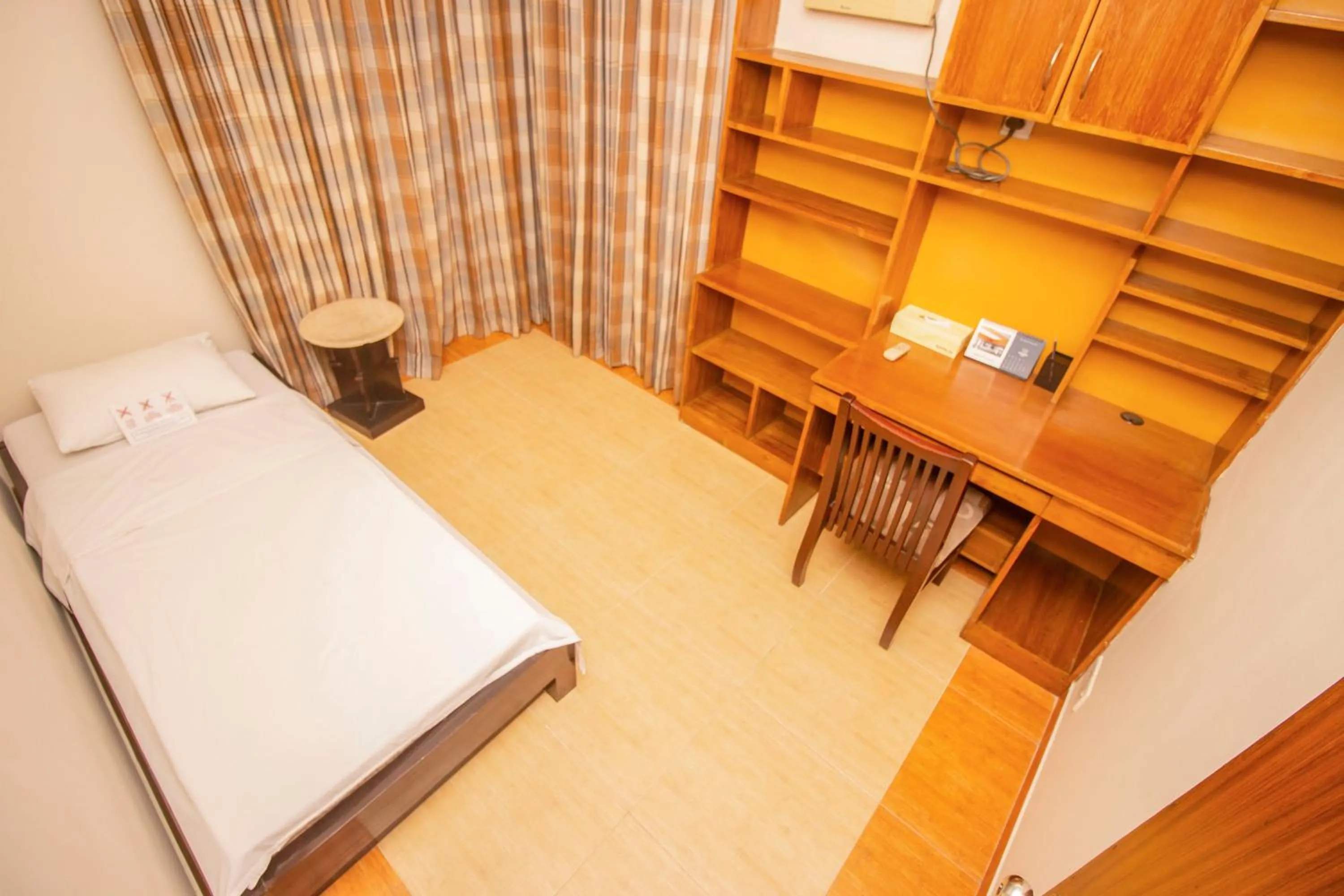 Seating area, Bed in Rafflesia Serviced Apartments