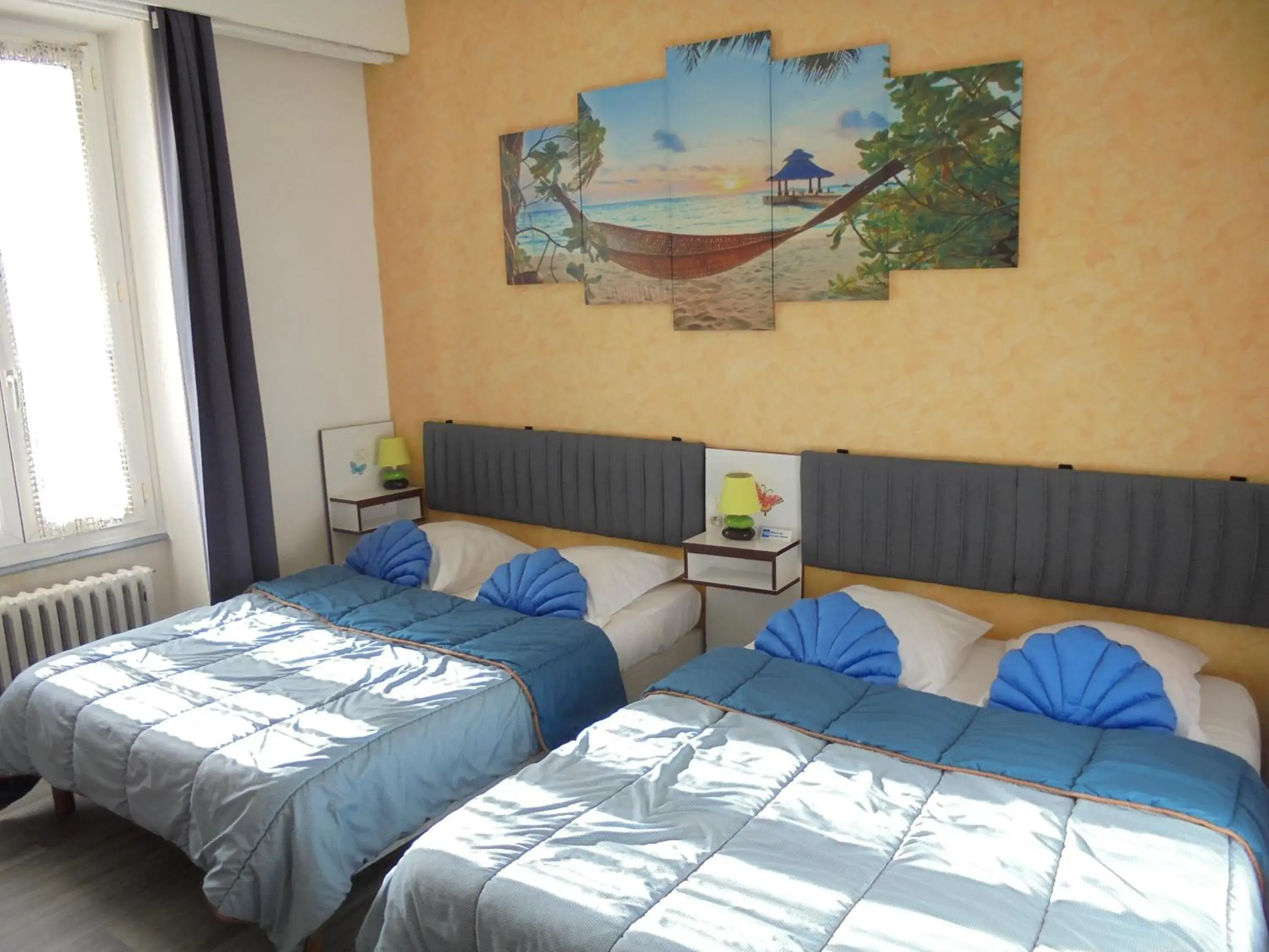 Quadruple Room with two Full Beds (2 Adults + 2 Children) in Hotel De La Gare Quadruple Room with two Full Beds (2 Adults + 2 Children) in Hotel De La Gare